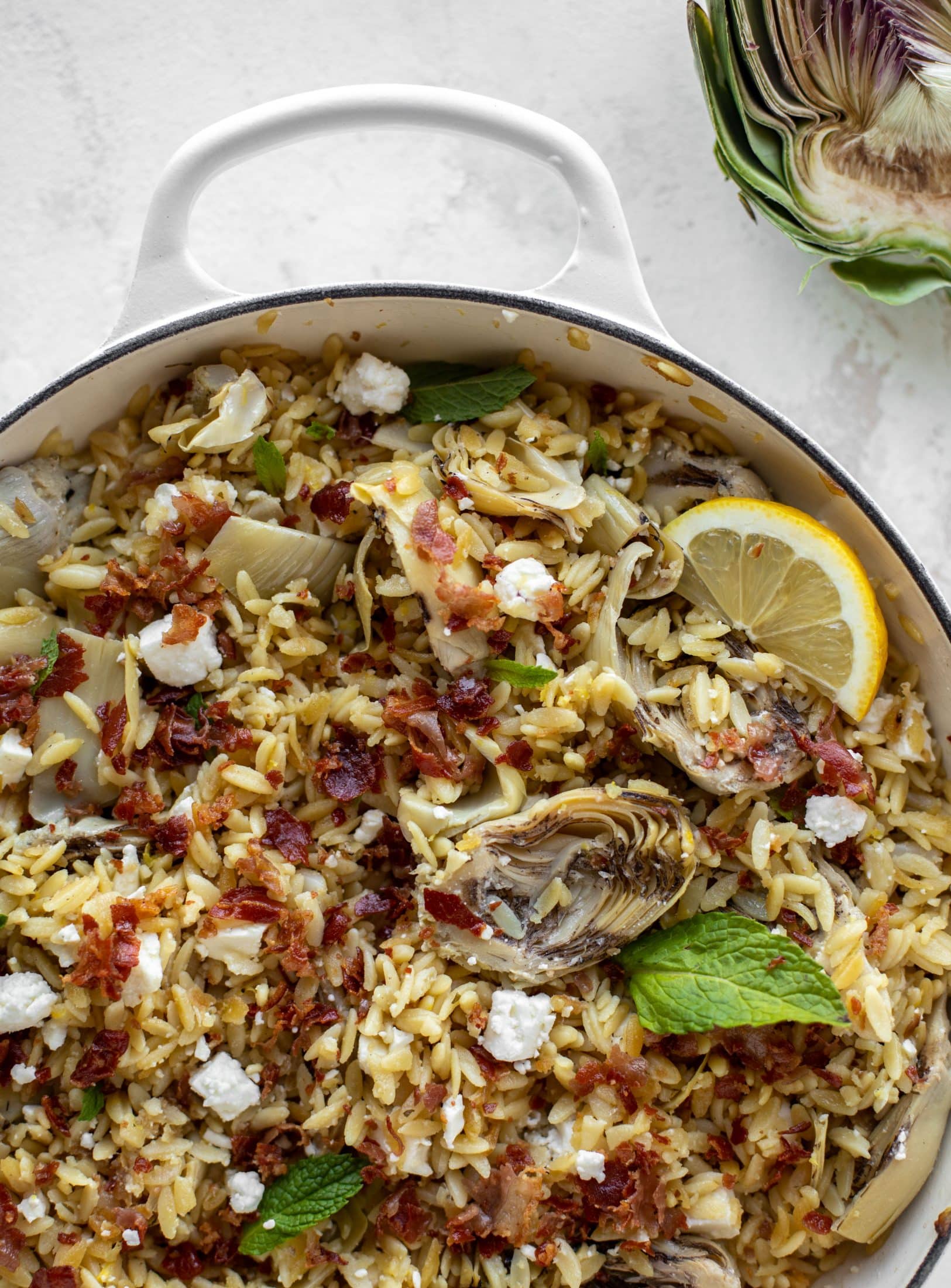 This crispy orzo is a wonderful spring dish. Artichoke hearts, lemon, goat cheese and herbs all topped with a sprinkling of crunchy prosciutto.
