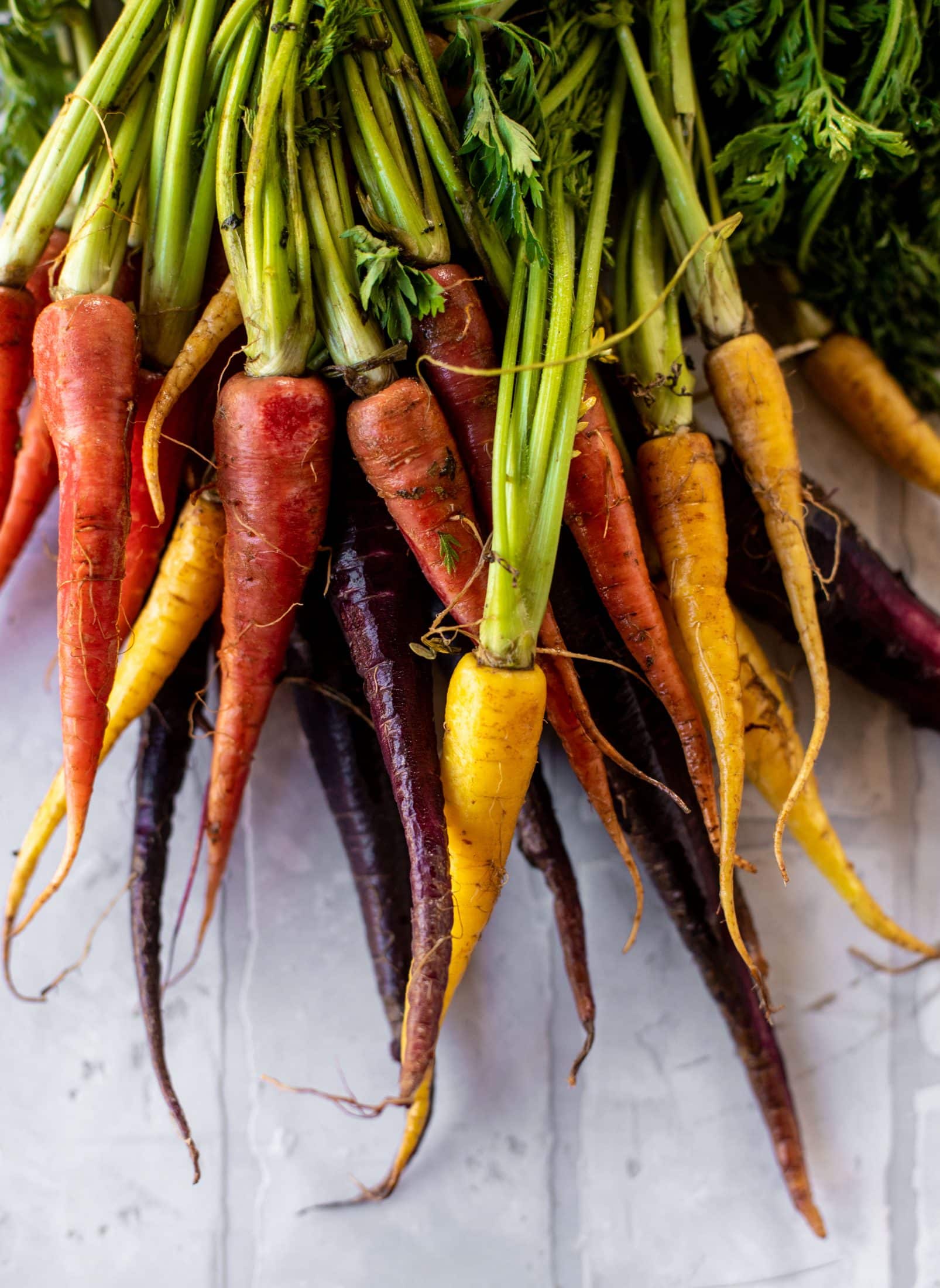 This roasted carrot salad is perfect for spring! Caramely, roasted carrots served over butter greens dressing with green goddess. Simple but delish.