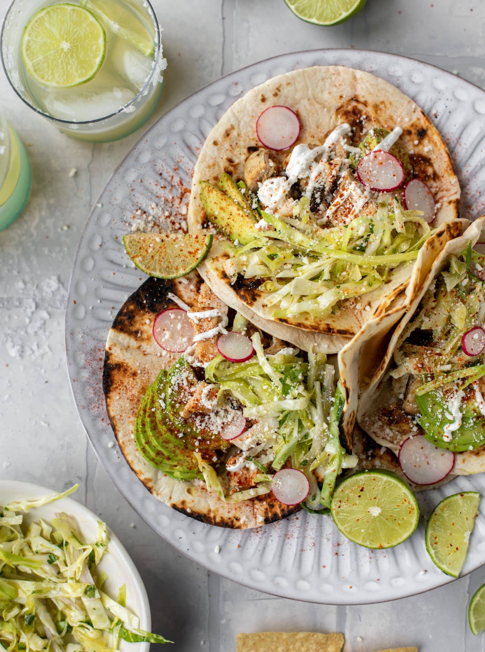 These grilled chicken tacos are easy and flavorful. They are super smoky, then topped with a key lime slaw that is absolutely delicious!