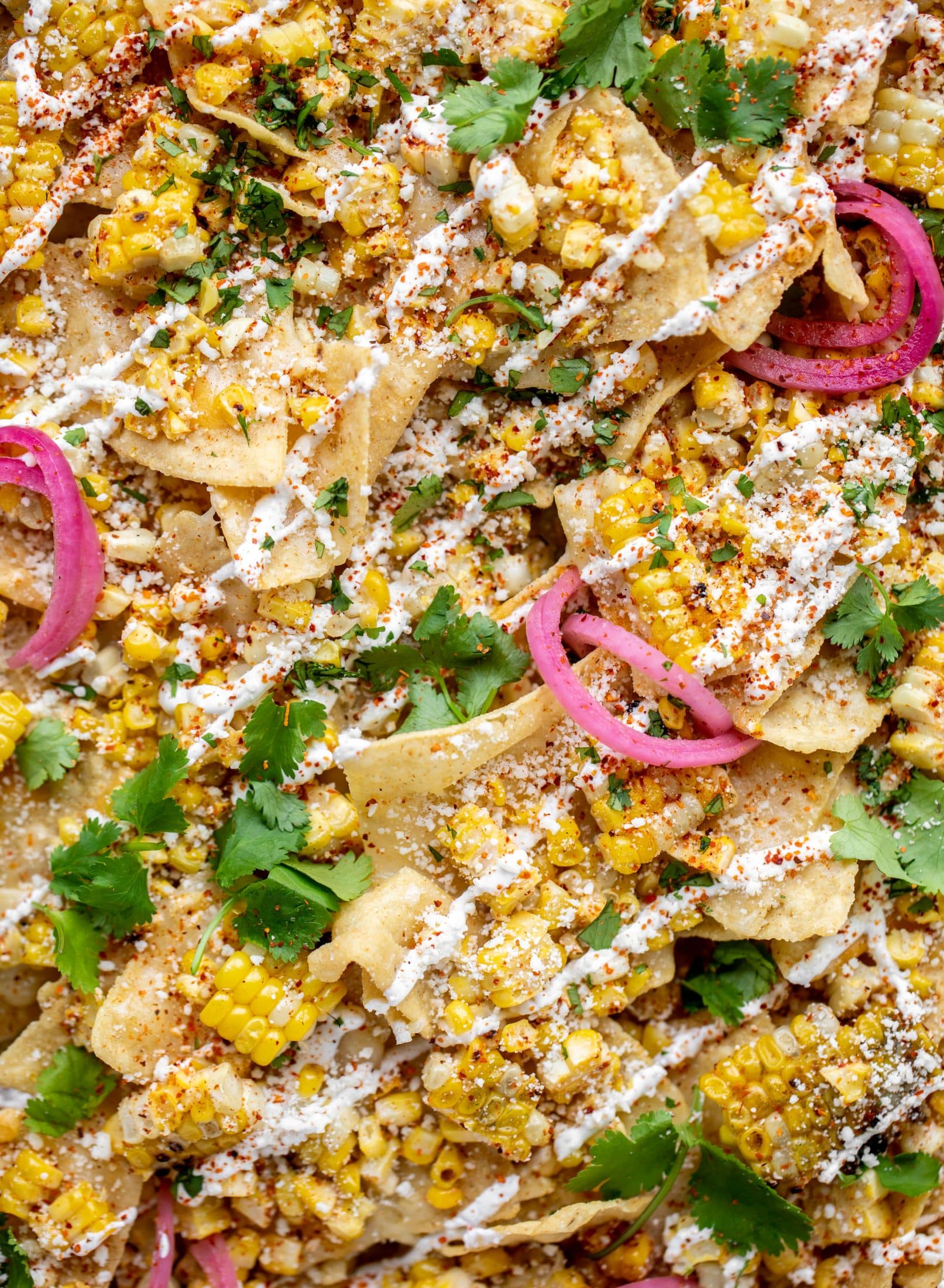 These sheet pan street corn nachos are ridiculously easy and delicious! Grilled corn, chili, lime, tons of cheese and all the flavor you could dream of!