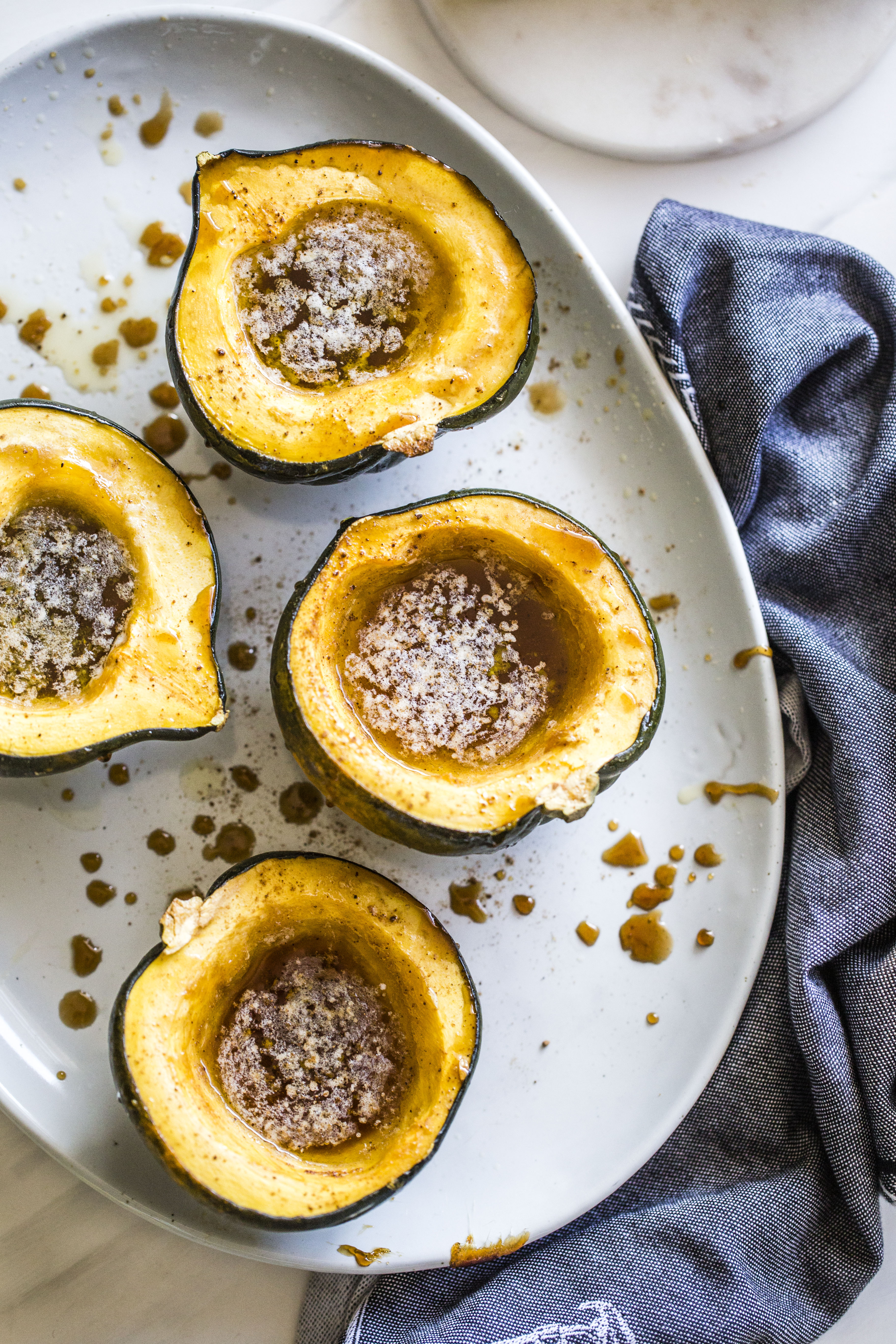 This baked acorn squash recipe is so delicious for the fall! It's made with vanilla and bourbon, finished with balsamic, is super easy, a bit indulgent and perfect for the season. Makes for a fabulous side dish in autumn or even a dessert! I howsweeteats.com #acorn #squash #baked #vanilla #bourbon