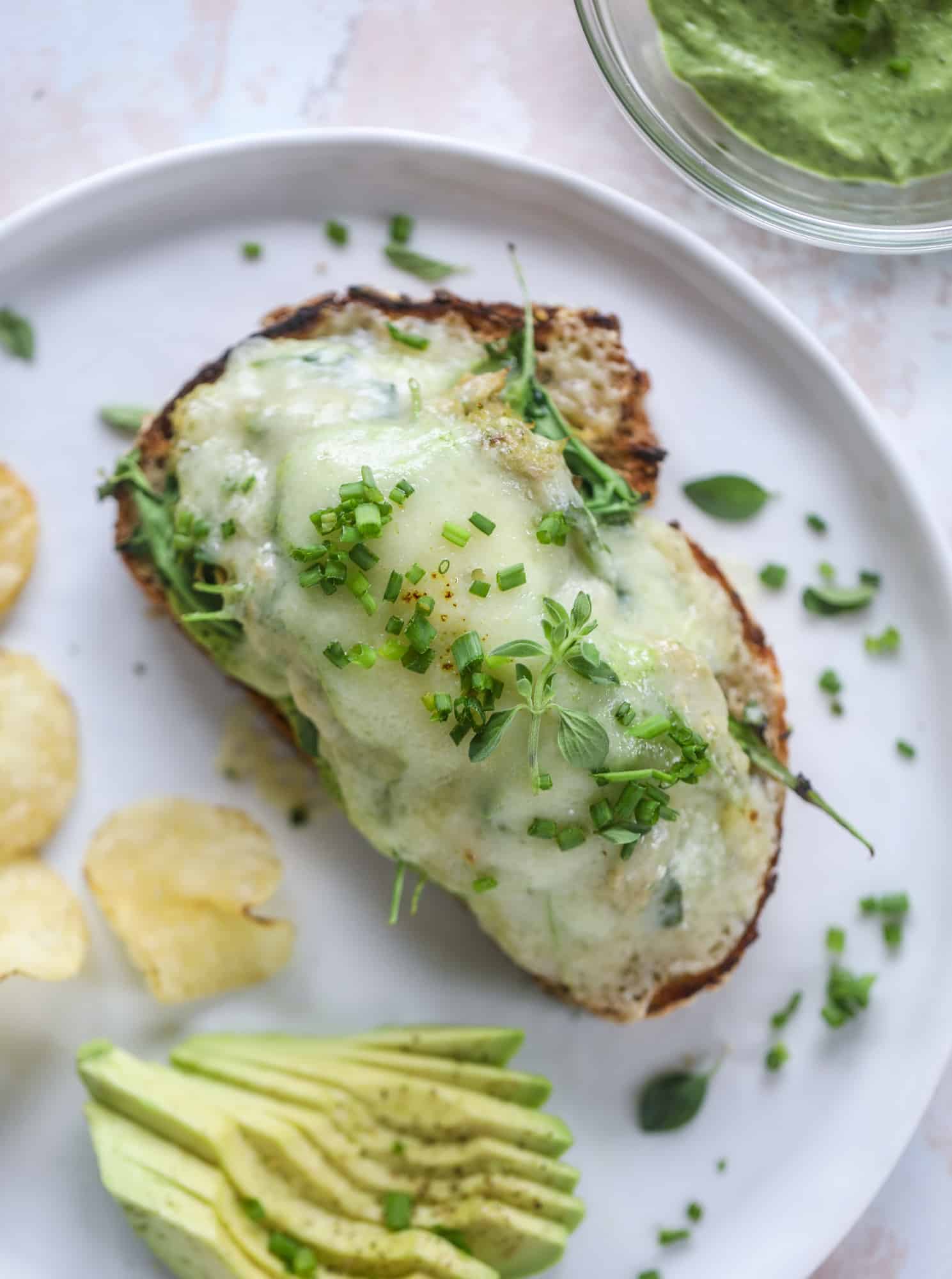 These green green tuna melt tartines are a lunch dream come true! The green goddess dressing is full of avocado, greek yogurt, spinach and fresh herbs. Paired with the tuna, whole grain toast and melty cheese, it's incredibly delicious and a super easy lunch! I howsweeteats.com #green #goddess #tune #salad #melts