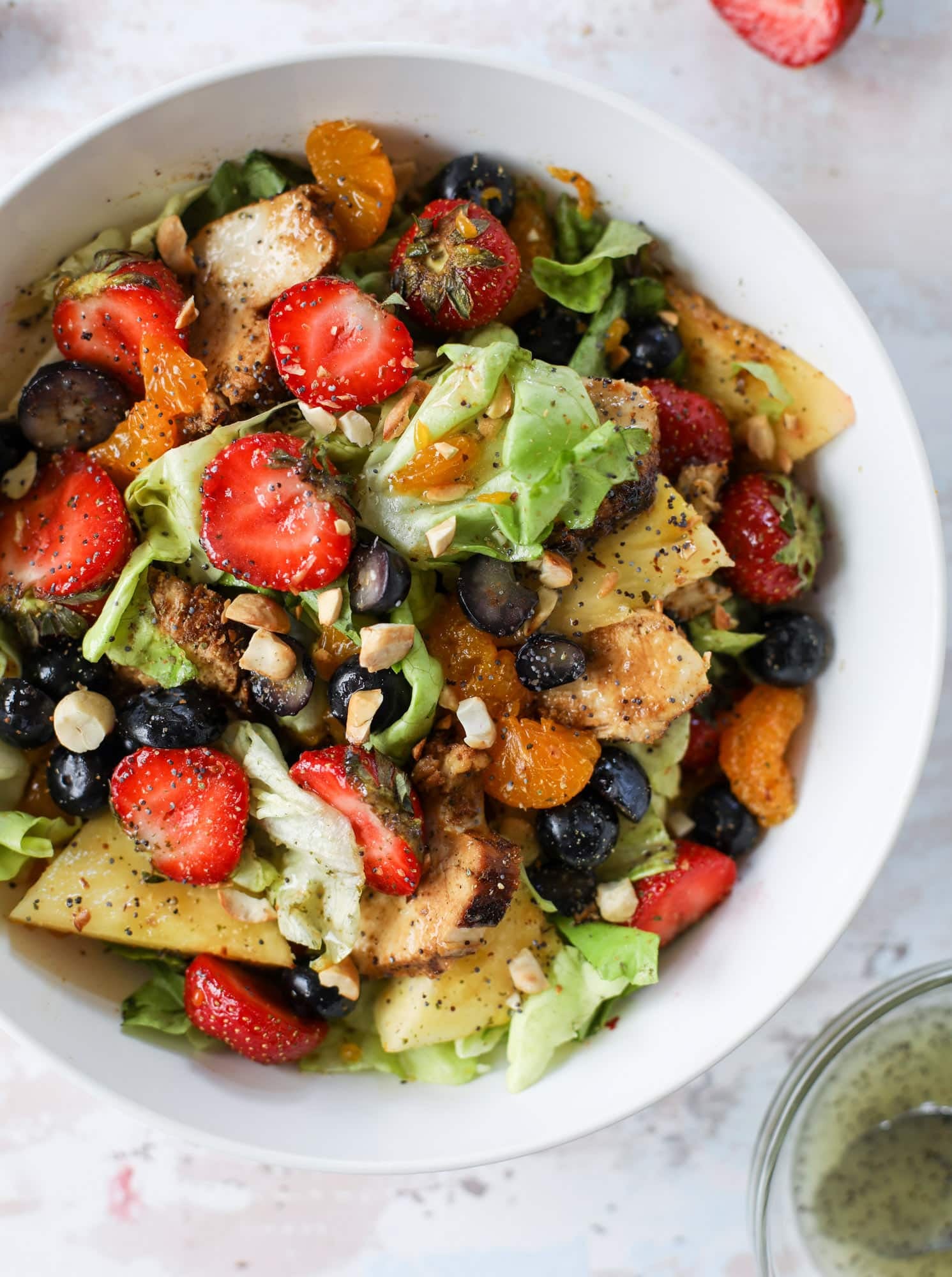 This copycat Panera strawberry poppyseed salad is absolutely delicious and refreshing and perfect for summer! Serve it with grilled chicken like the recipe here or swap for shrimp or fish. I howsweeteats.com #strawberry #poppyseed #salad #chicken #panera #copycat