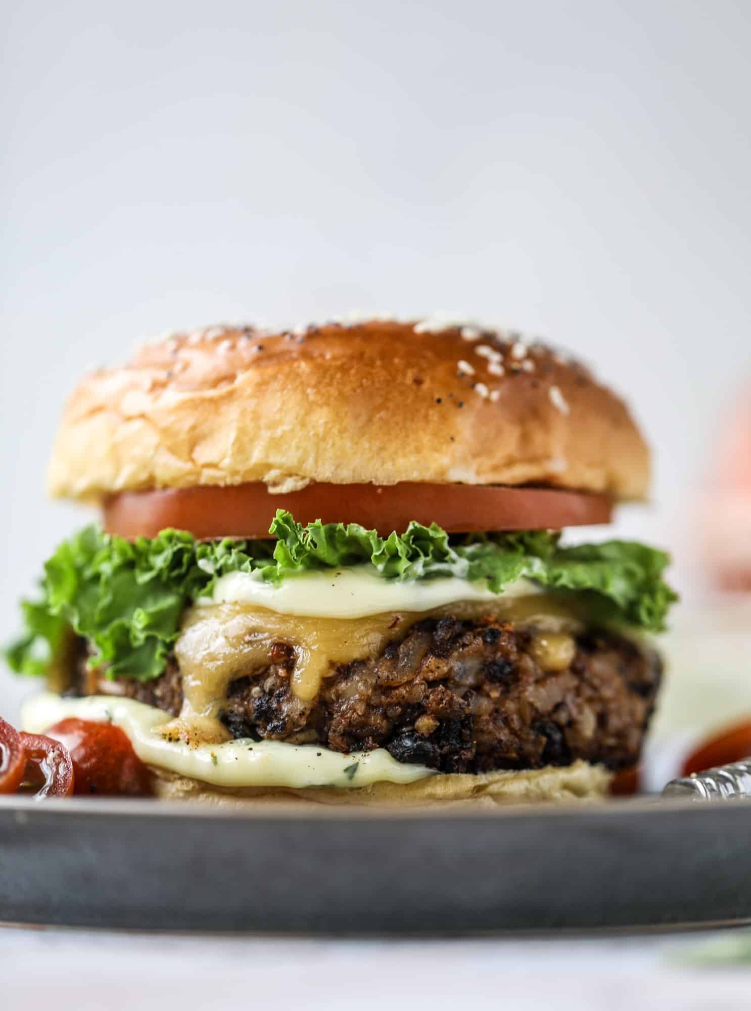 This is the best ever veggie burger and that is not an exaggeration! It's delicious, full of texture and chew, super satisfying and actually sticks together in the pan. You can serve it on buns, make a patty melt, a salad or lettuce wraps - perfection! I howsweeteats.com #best #veggie #burger #vegetarian #beans #quinoa