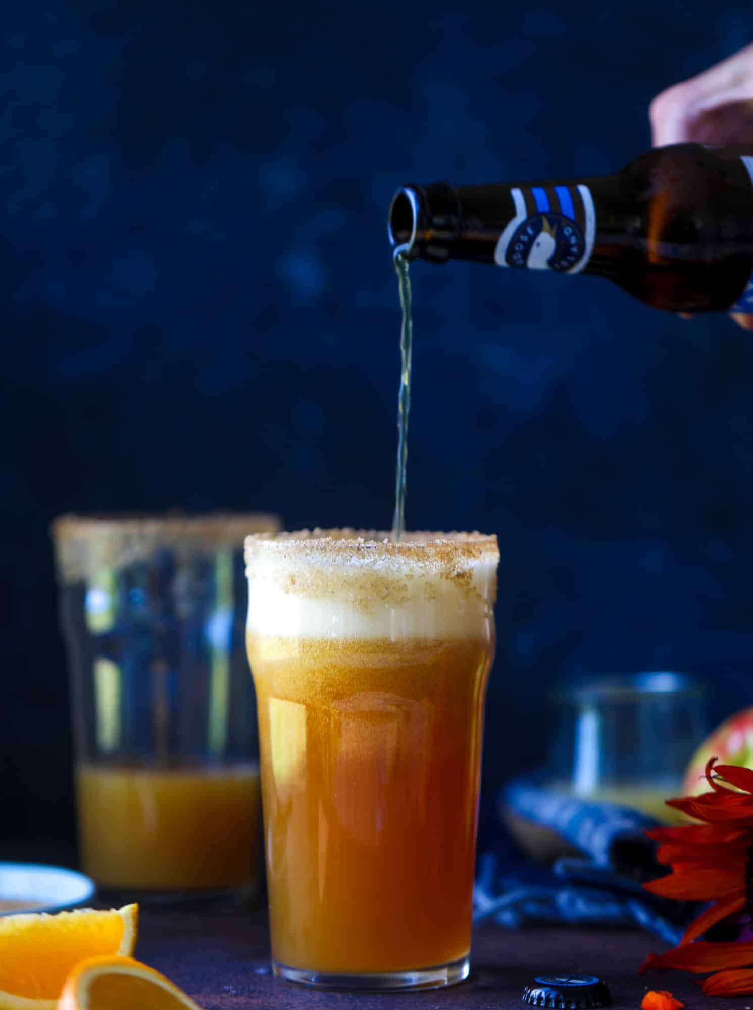 This apple cider shandy recipes is perfect for the fall season! Apple cider, sparkling cider and your favorite beer come together in an icy glass to create the best flavor ever. Finished with a cinnamon sugar rim, there's nothing better! I howsweeteats.com #apple #cider #shandy #cocktails #beer