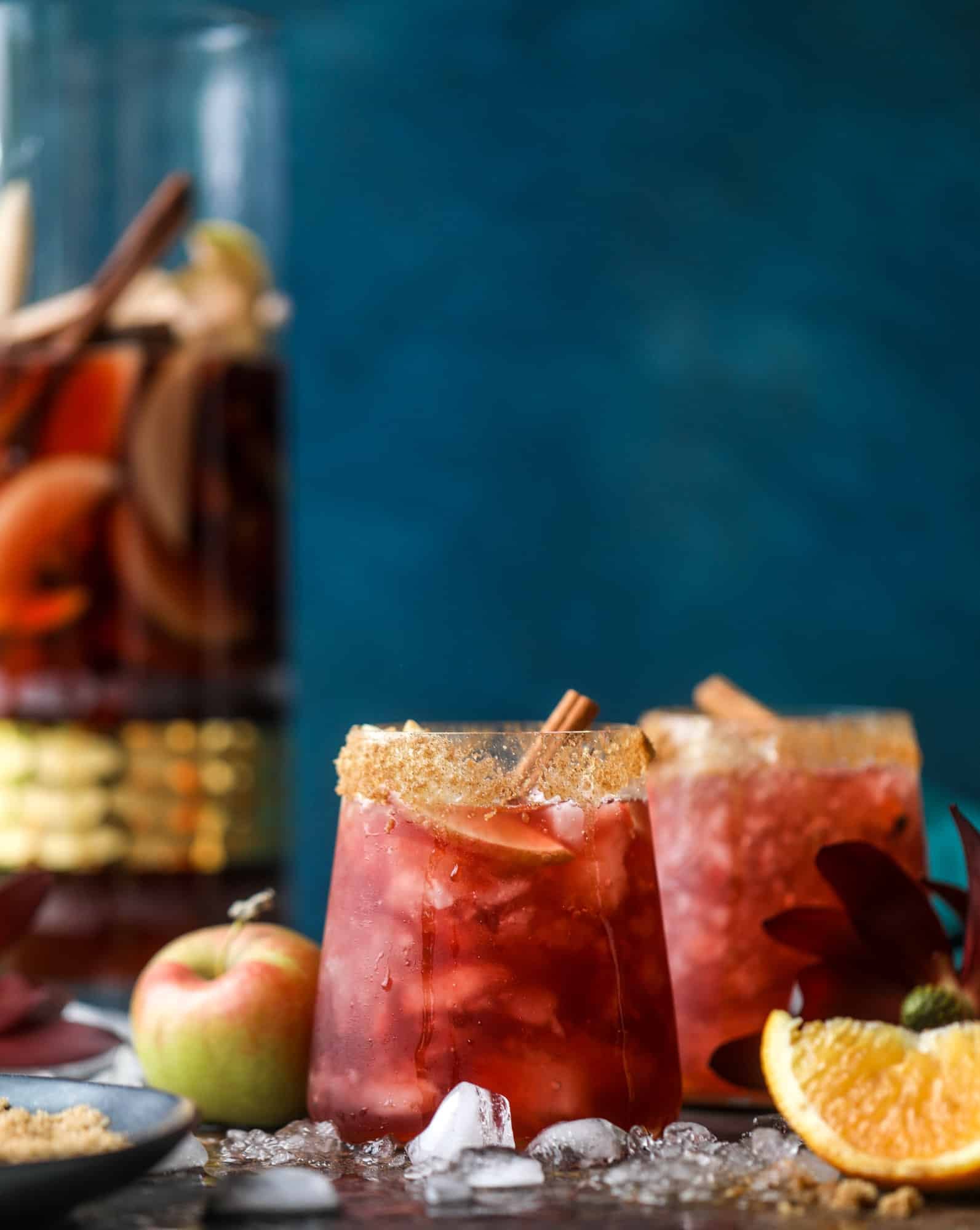 This red apple cider sangria will soon because a staple for your fall! It's delicious and not too sweet, with a base of red wine, apple cider and maple syrup. Cinnamon sticks and apple slices round out the pitcher and it's so flavorful and perfect for the season! I howsweeteats.com #red #apple #cider #sangria