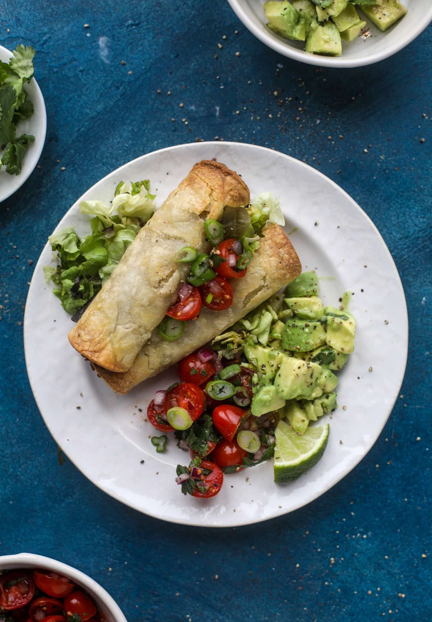 Saucy baked black bean taquitos have a crunchy outside and a creamy, flavorful inside. Served with a pico de gallo, they are an easy weeknight meal! I howsweeteats.com #baked #taquitos