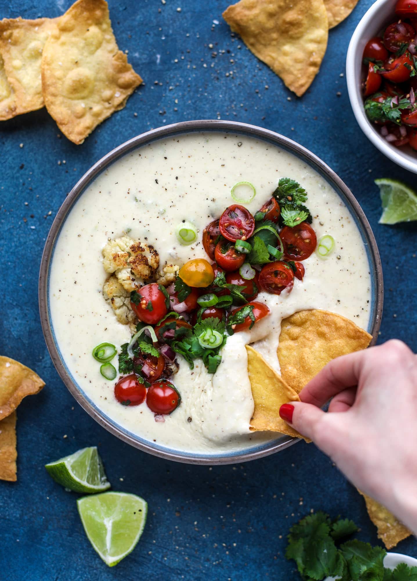 This roasted cauliflower queso has all the deliciousness of regular queso, with roasted cauliflower added in. It's satisfying and tastes like heaven. I howsweeteats.com #cauliflower #queso