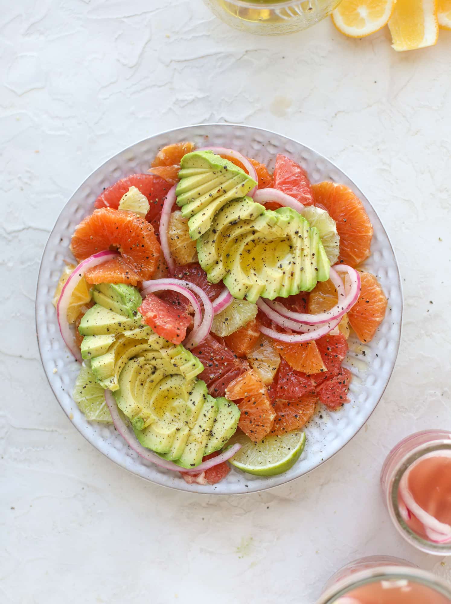 A deliciously fresh and invigorating avocado citrus salad with honey lime vinaigrette. It's creamy, tart, sweet and refreshing! I howsweeteats.com #avocado #citrussalad