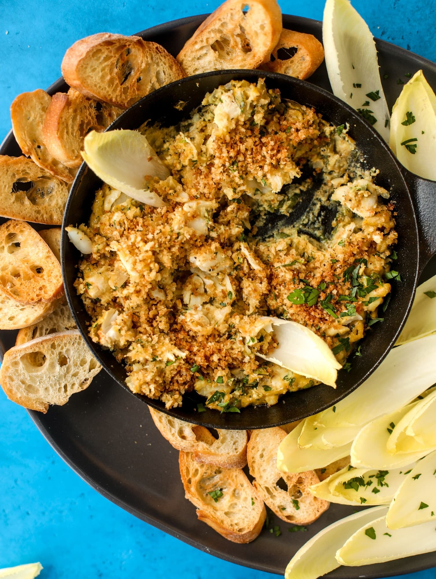 This deviled crab dip is the perfect hot summer appetizer. Lump crab, a creamy, decadent sauce, crunchy breadcrumbs and fresh endive for dipping. YES.