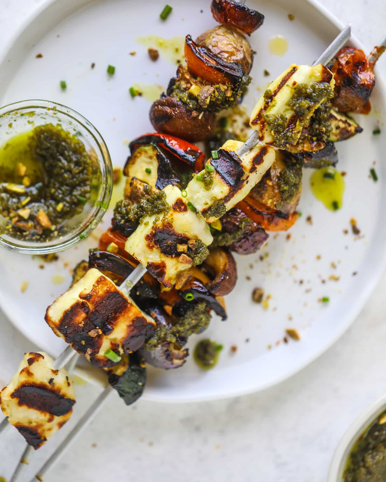 My all time favorite grilled vegetable skewers served with grilled halloumi cheese and pistachio pesto! Makes the best summer meal ever.
