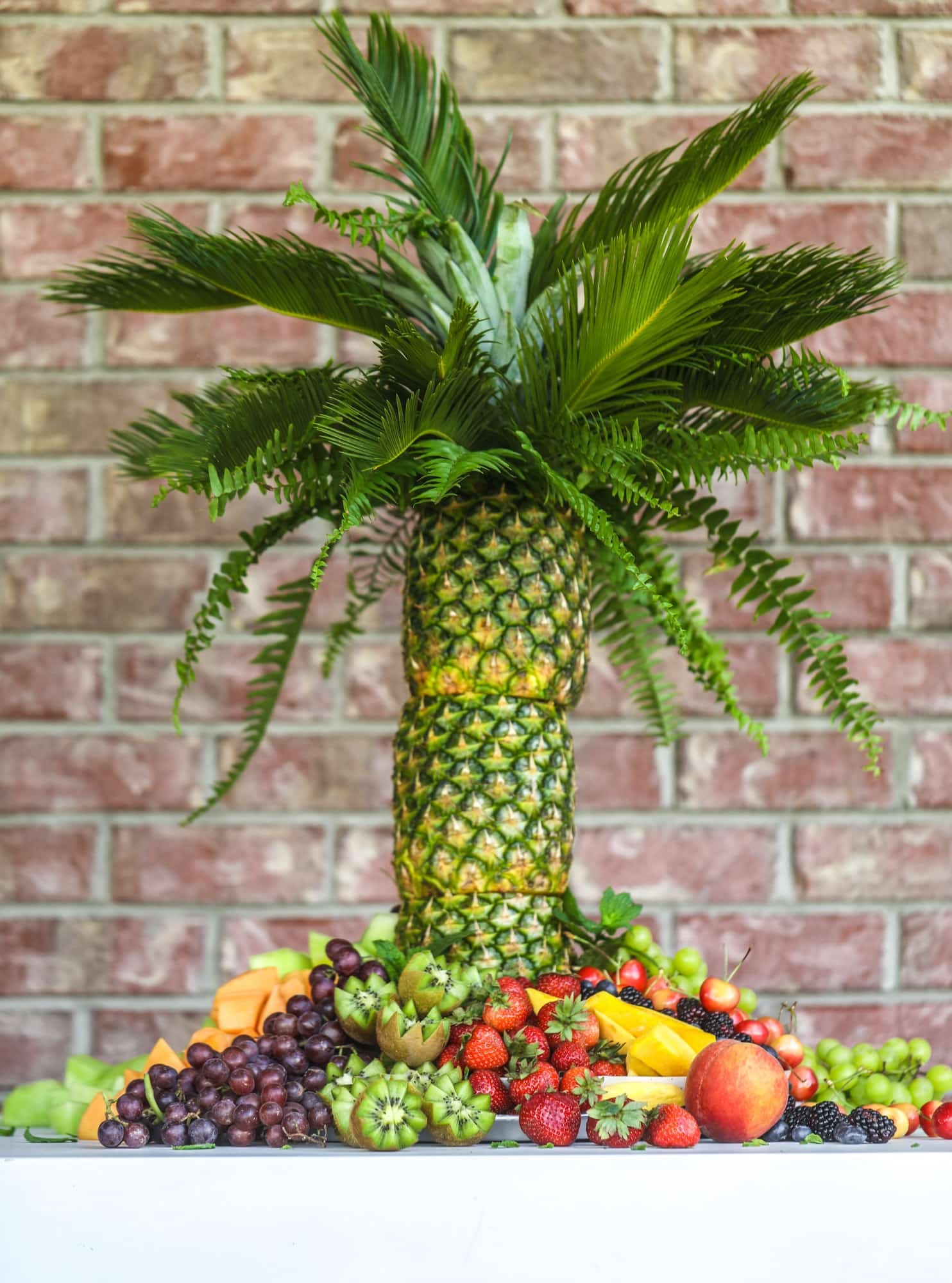 This is the cutest way to display fruit! A pineapple palm tree fruit tray will be the star of the show at your next summer BBQ or party! 