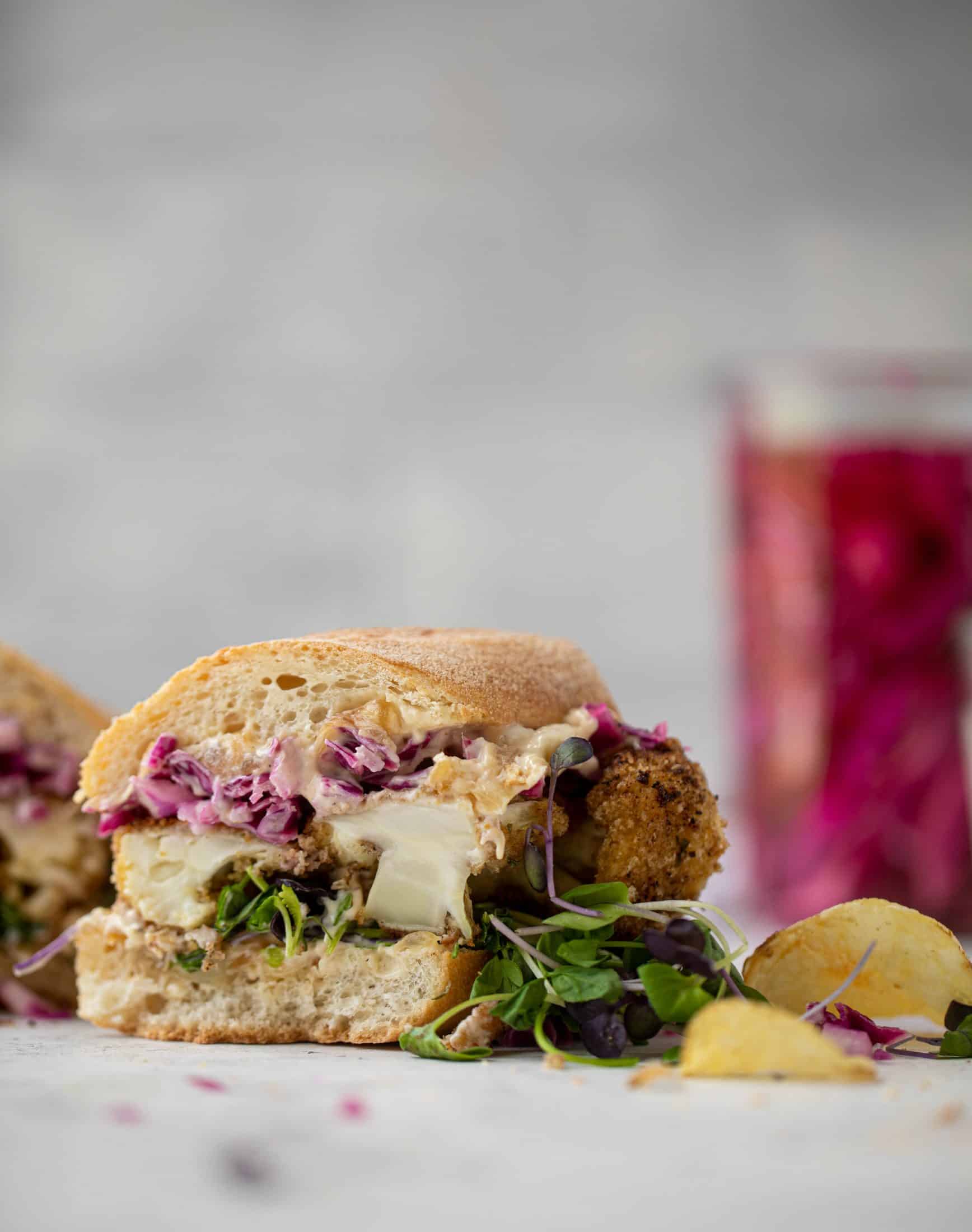 These cauliflower schnitzel sandwiches are full of flavor! Crispy cauliflower, caramelized onion mayo, pickled cabbage and microgreens. Delish!