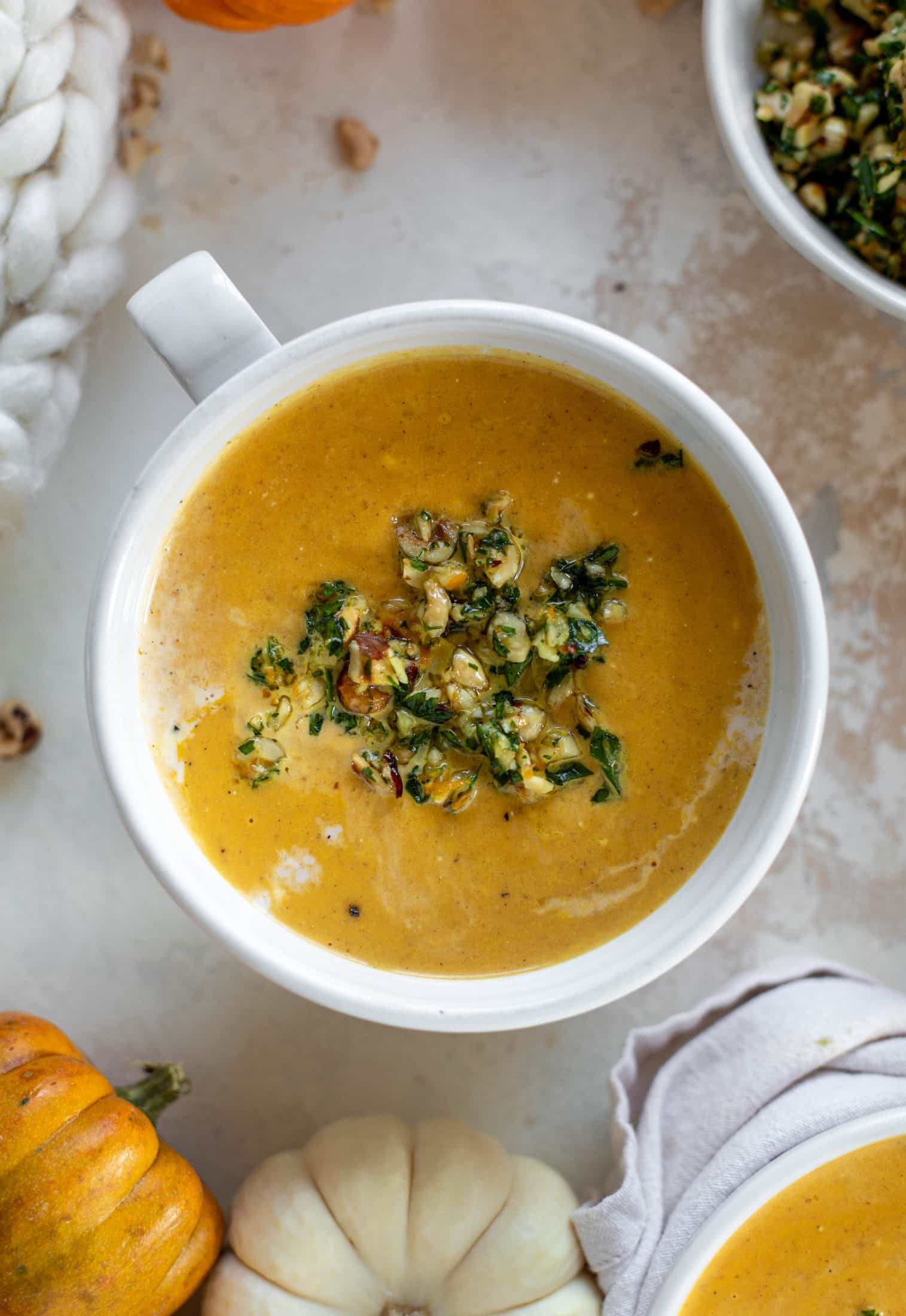 This pumpkin cream soup is silky smooth and delicious, then topped with a roasted hazelnut gremolata for extra flavor and crunch!