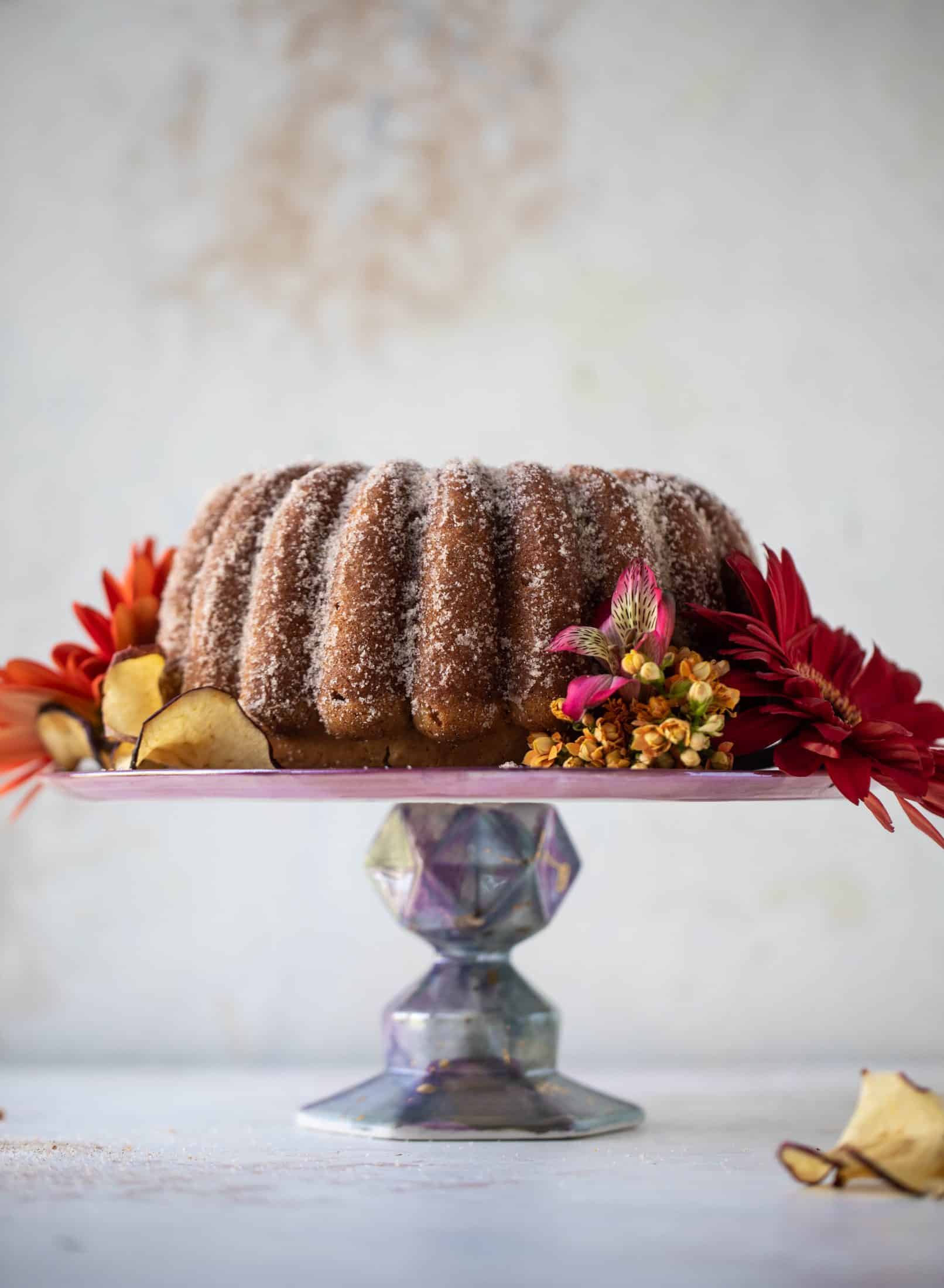 This apple cider donut cake is a huge fall crowd pleaser! Covered in cinnamon sugar and fluffy to perfection. It's incredible!