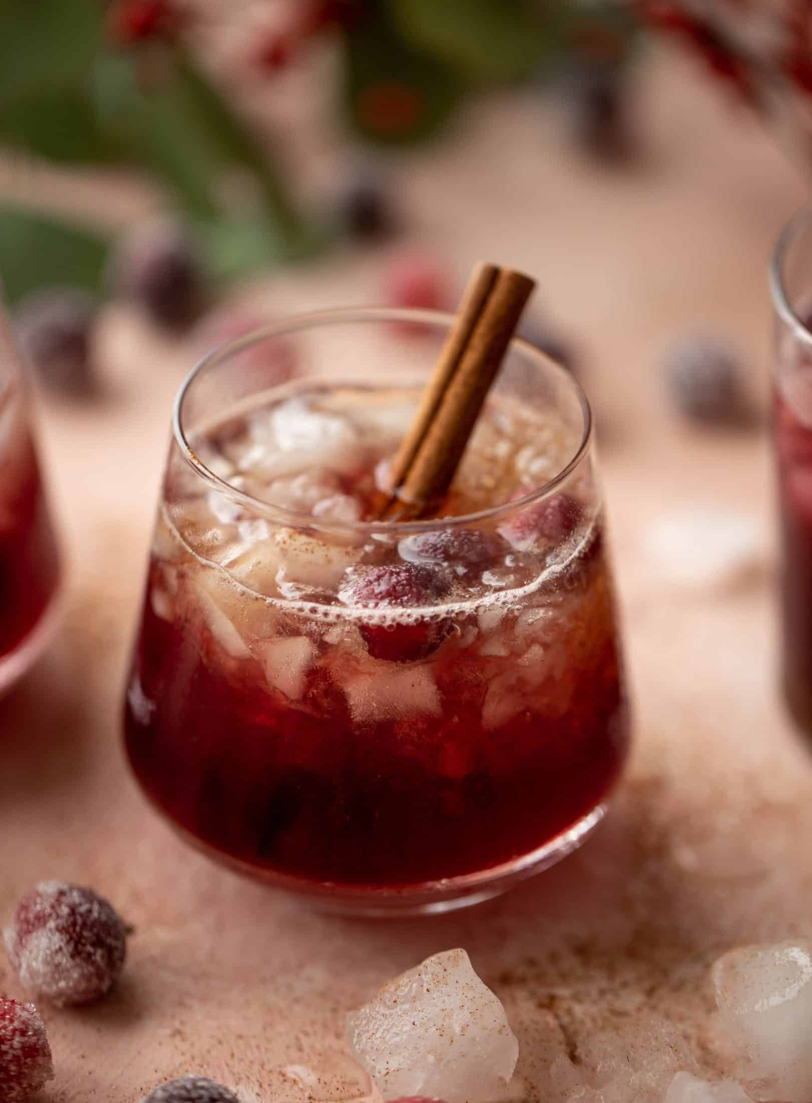 This cranberry cobbler smash is perfect for the holiday season! Bourbon, cinnamon simple syrup and cranberry juice - it's spiced and warming and wonderful.