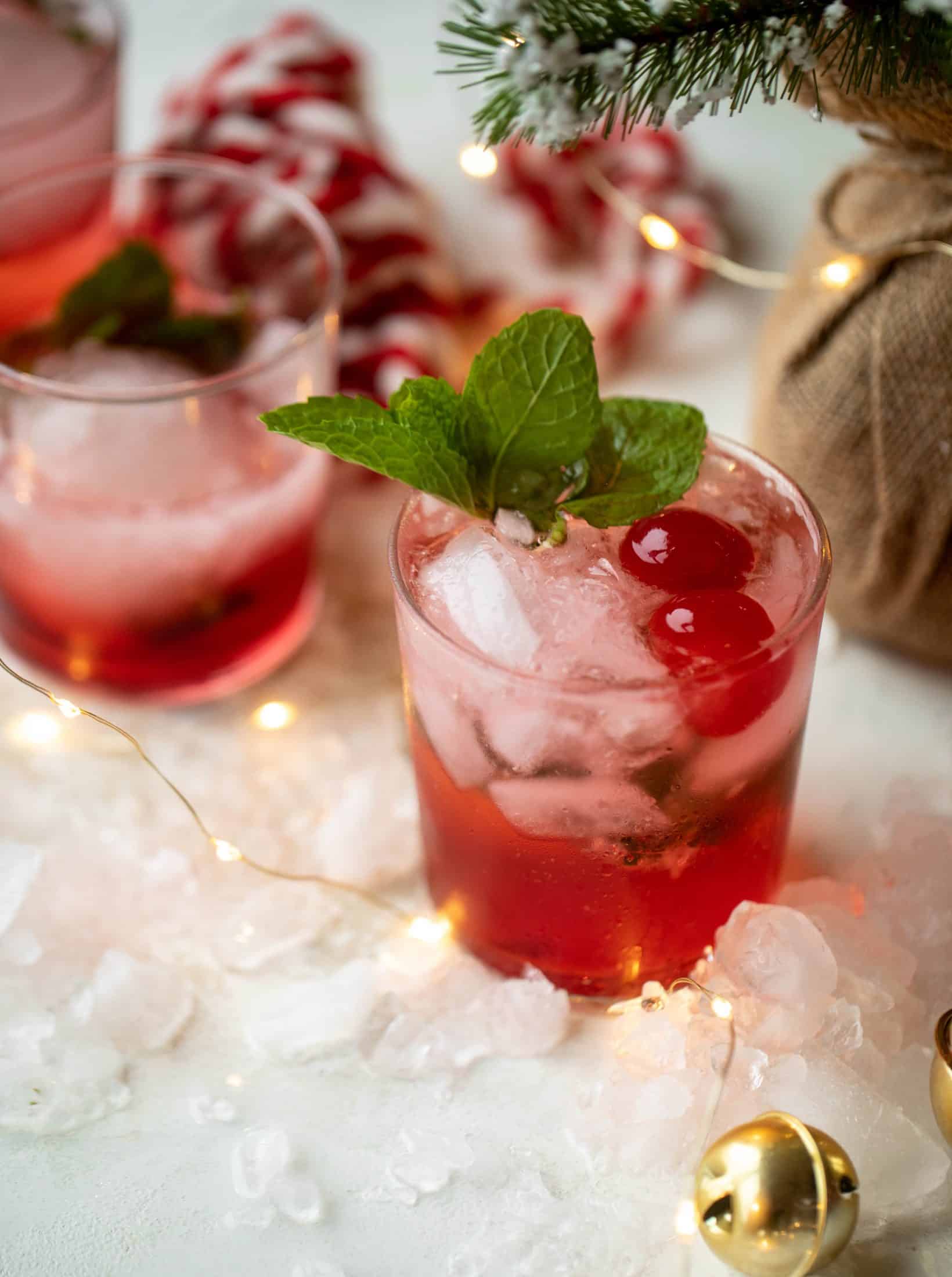 The merry cherry christmas cocktail is here! Vodka and cherries and mint, oh my! This is such a fun drink that can be made into a punch. It's delicious!