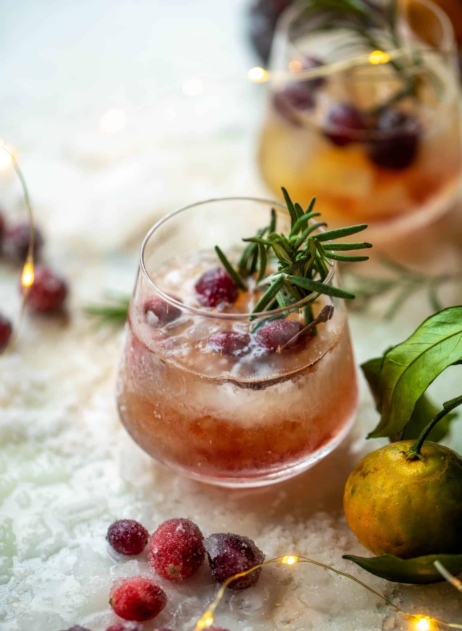 The mistletoe manhattan is a fun holiday spin on the classic manhattan cocktail! Sugared cranberries and rosemary make this super festive.