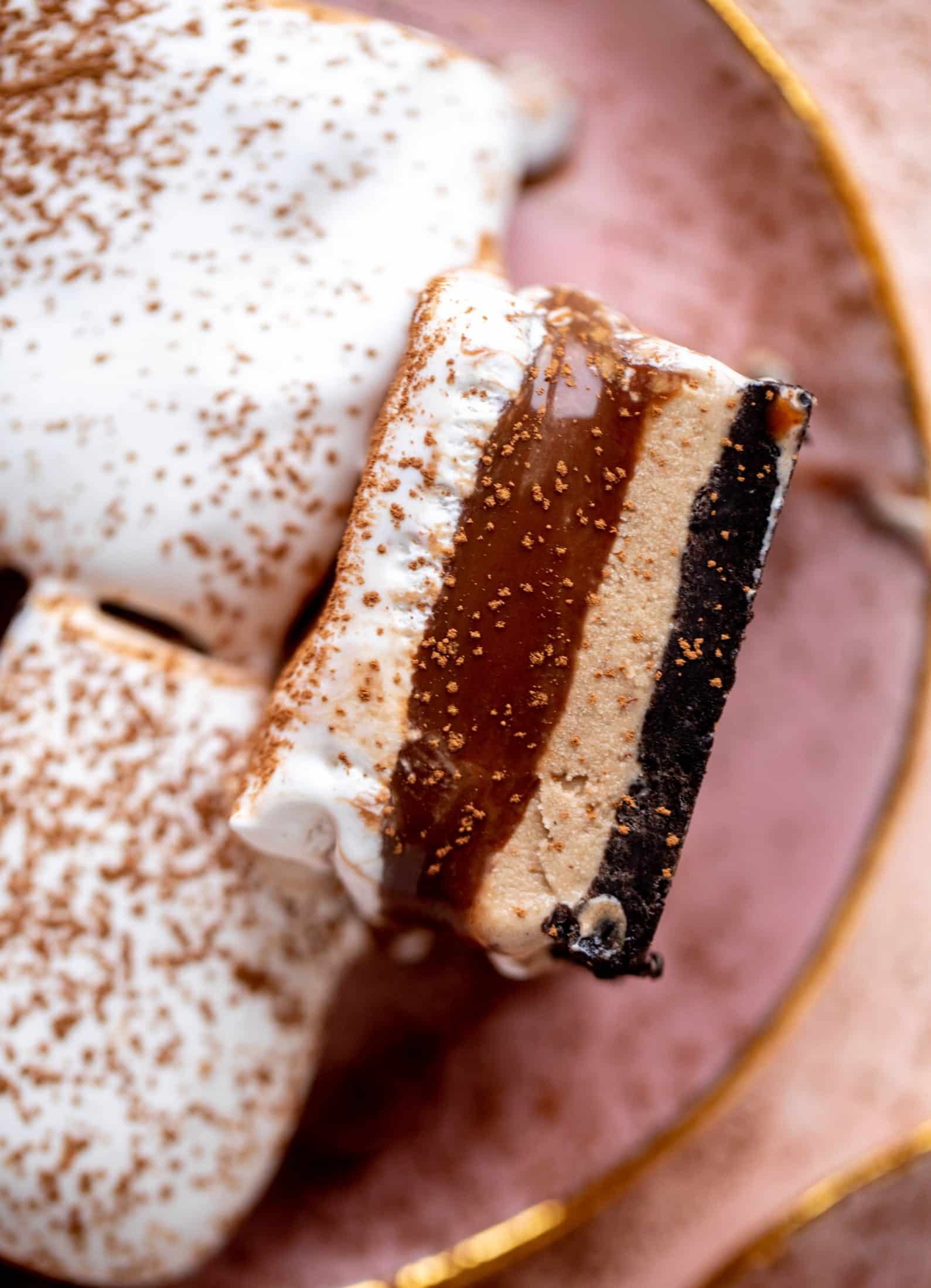 This frozen chocolate cookie dessert is a twist on the classic 90s recipe! Cookie crust, ice cream, homemade hot fudge and whipped cream. It's amazing!