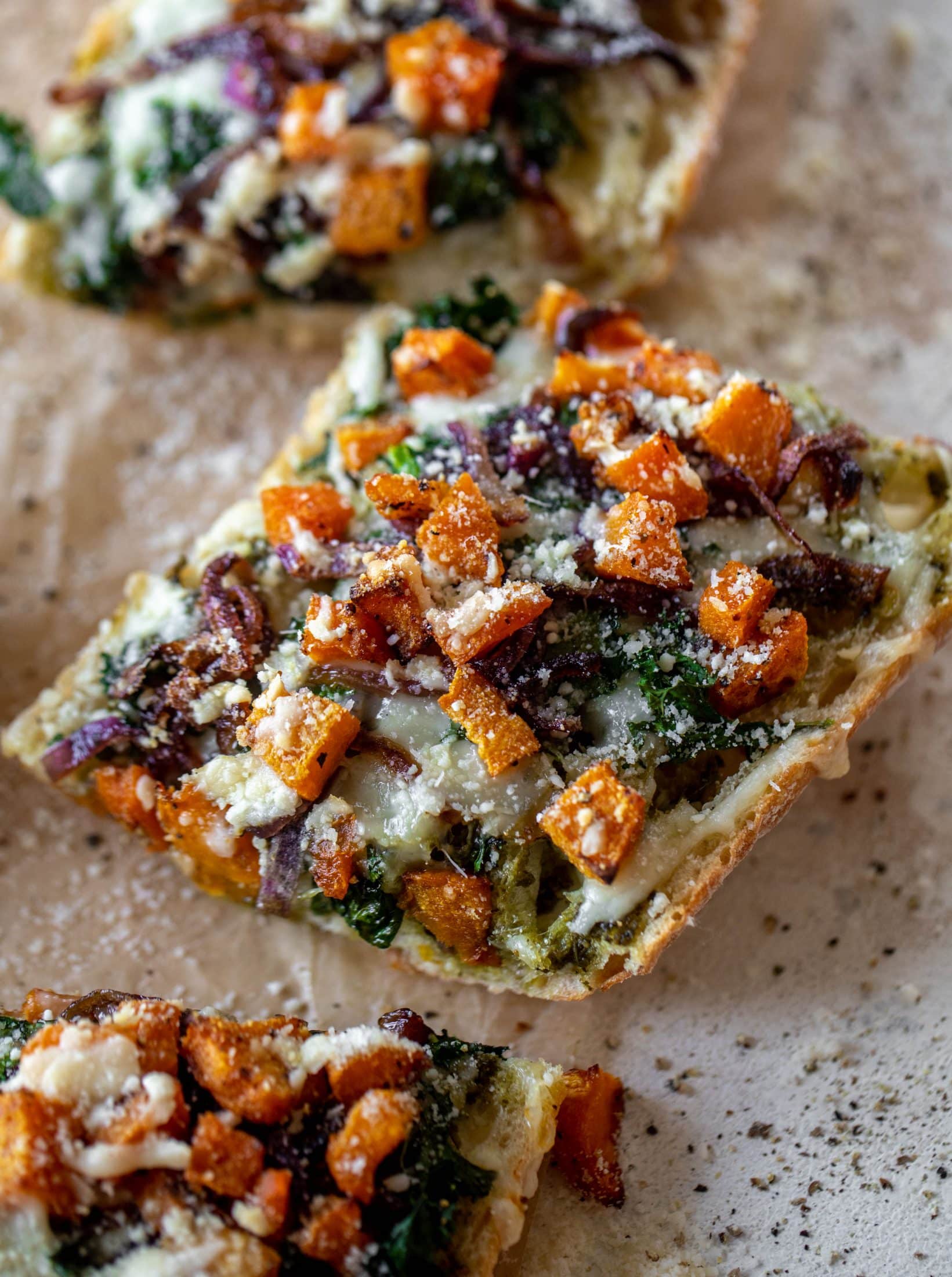 These butternut squash french breads have so much flavor. Pesto, caramelized onions, kale, roasted butternut and tons of fontina cheese. Delicious! 