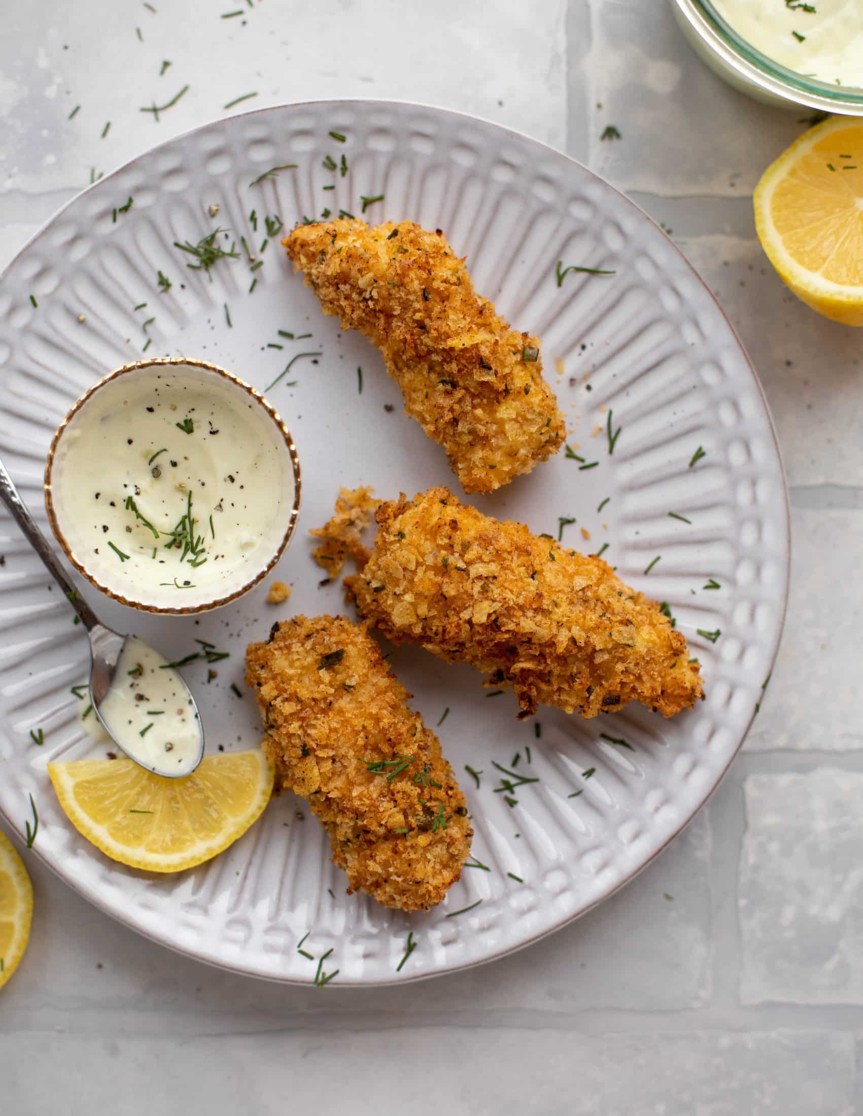 These crispy homemade fish sticks are flavored with lemon and garlic! They are super crunchy and delicious when dipped in the jalapeño tartar sauce.