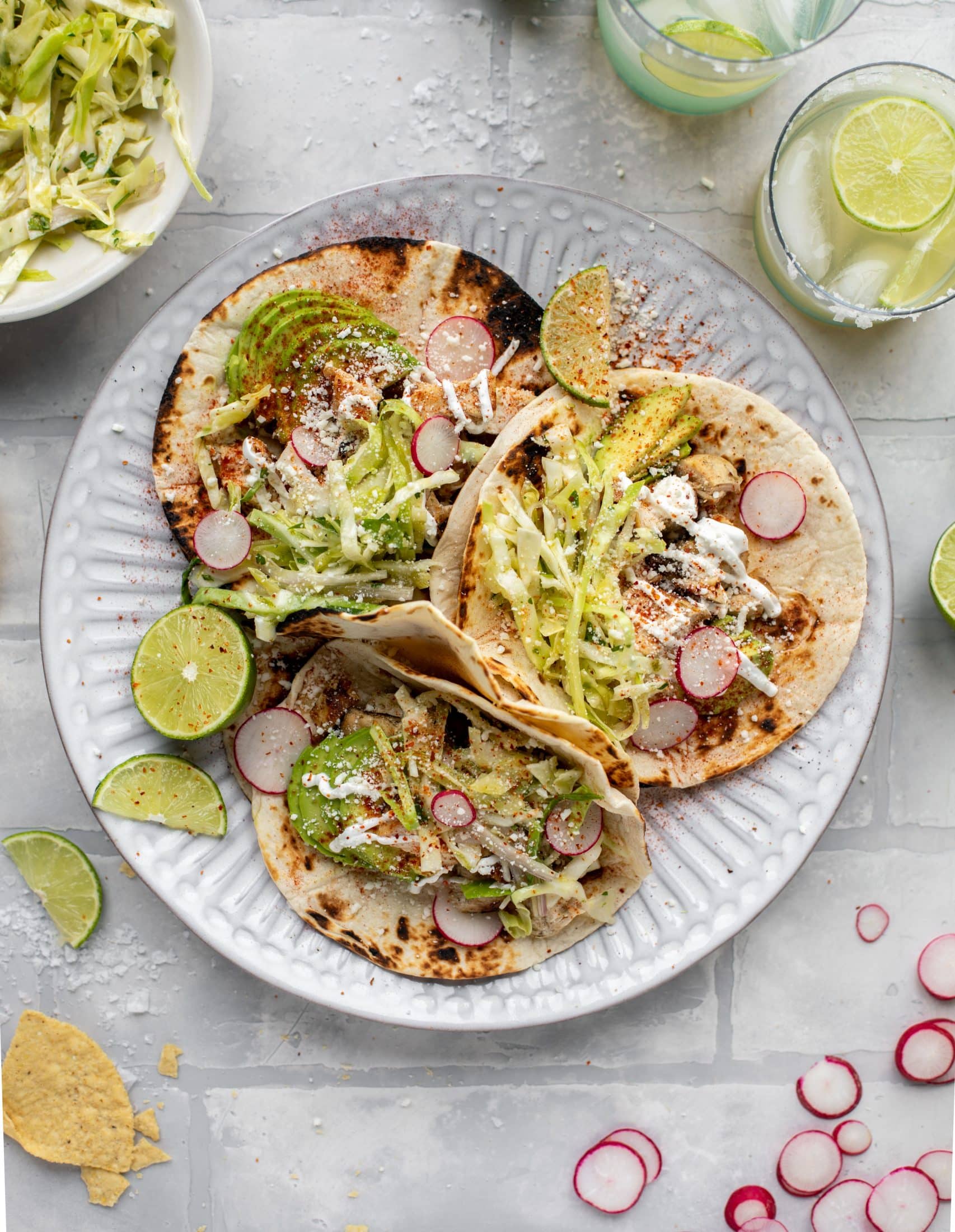 These grilled chicken tacos are easy and flavorful. They are super smoky, then topped with a key lime slaw that is absolutely delicious!