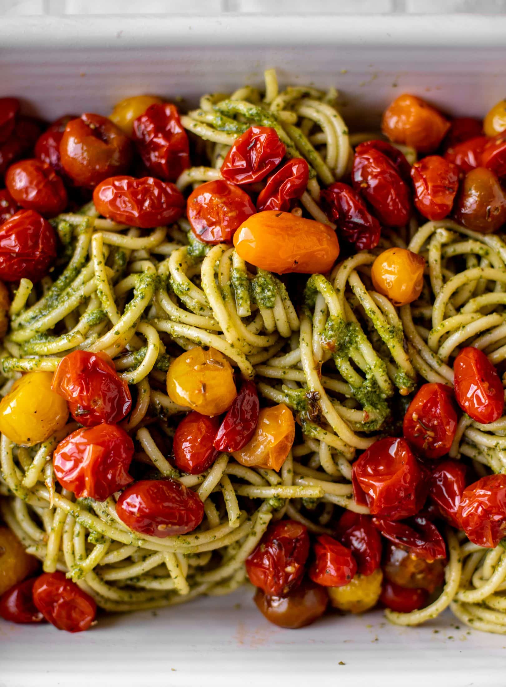 baked pesto bucatini with burst tomatoes
