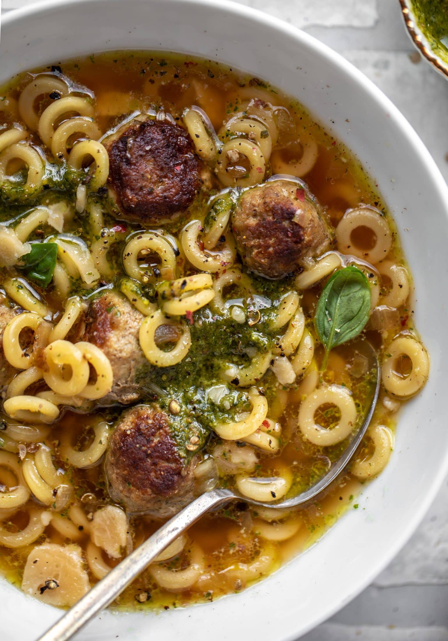 summer pesto mini meatball soup with spoon