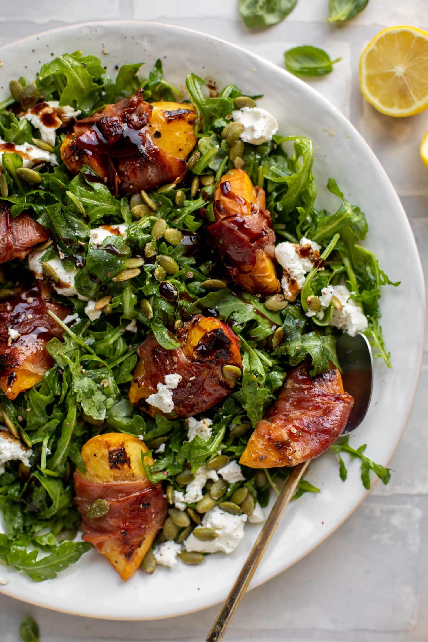 grilled prosciutto wrapped peaches with arugula and goat cheese