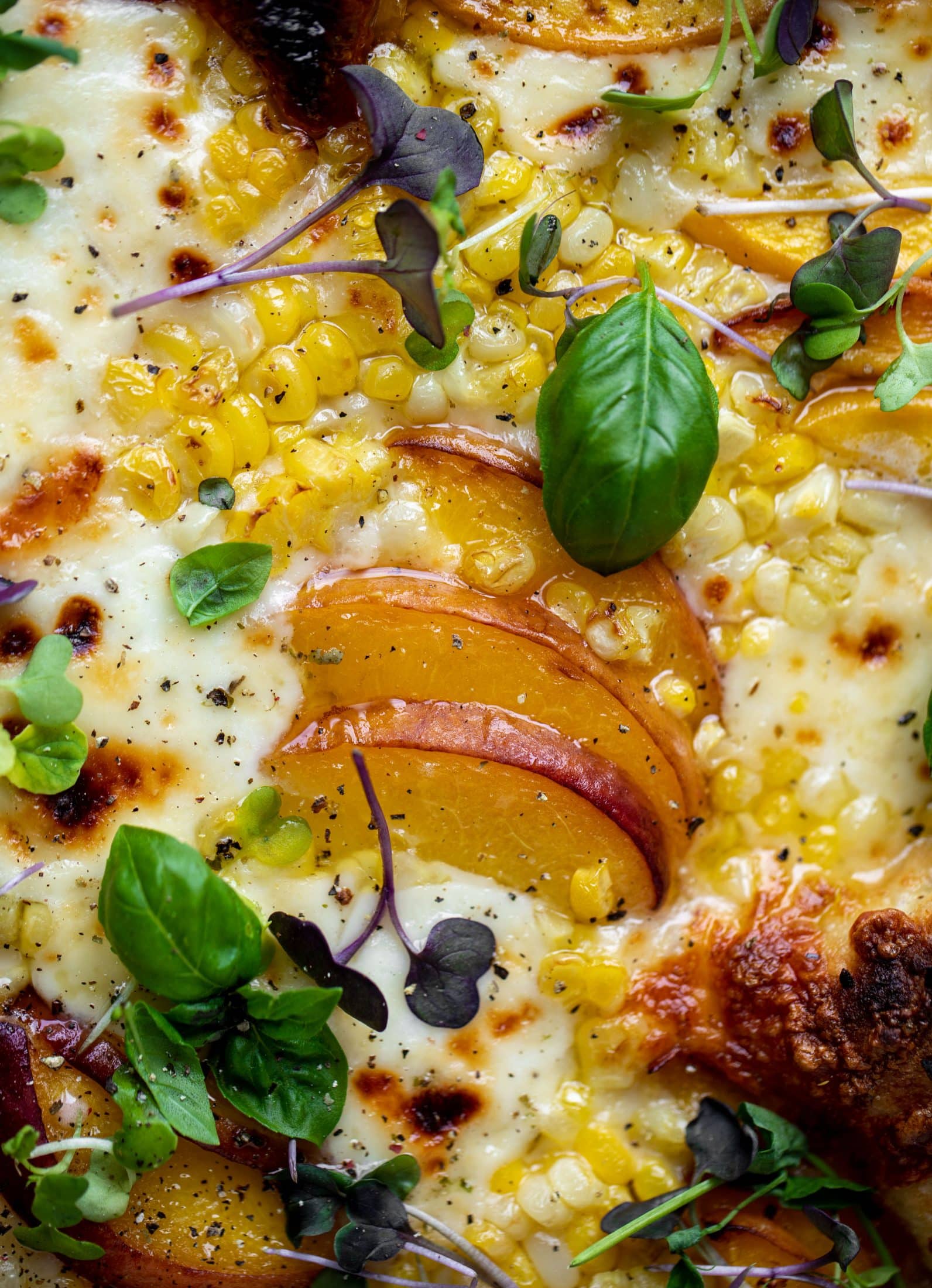grilled peach pizza with corn and chili garlic oil