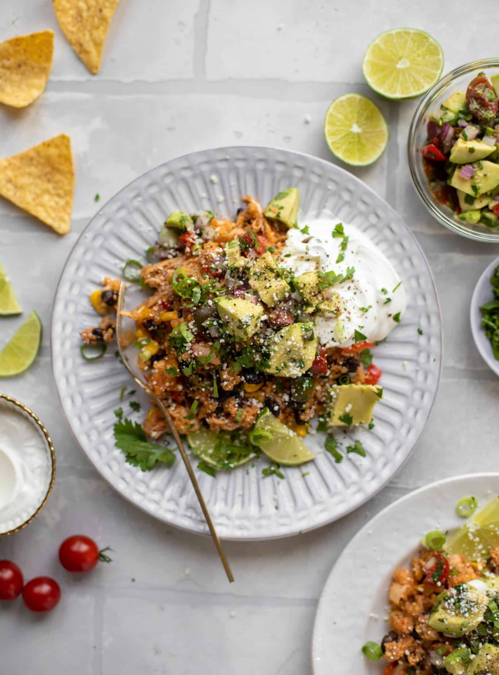 one pot salsa chicken quinoa topped with avocado pico de gallo