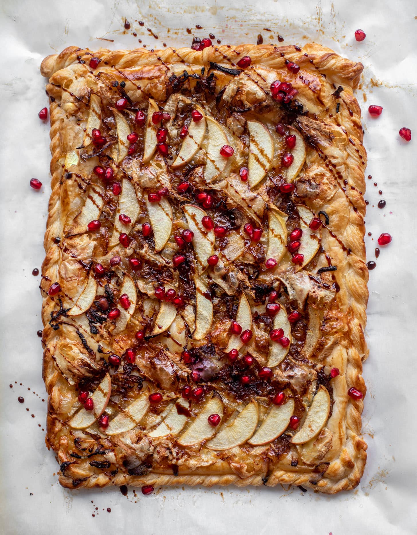 caramelized onion, apple and brie puff pastry tart with pomegranate molasses