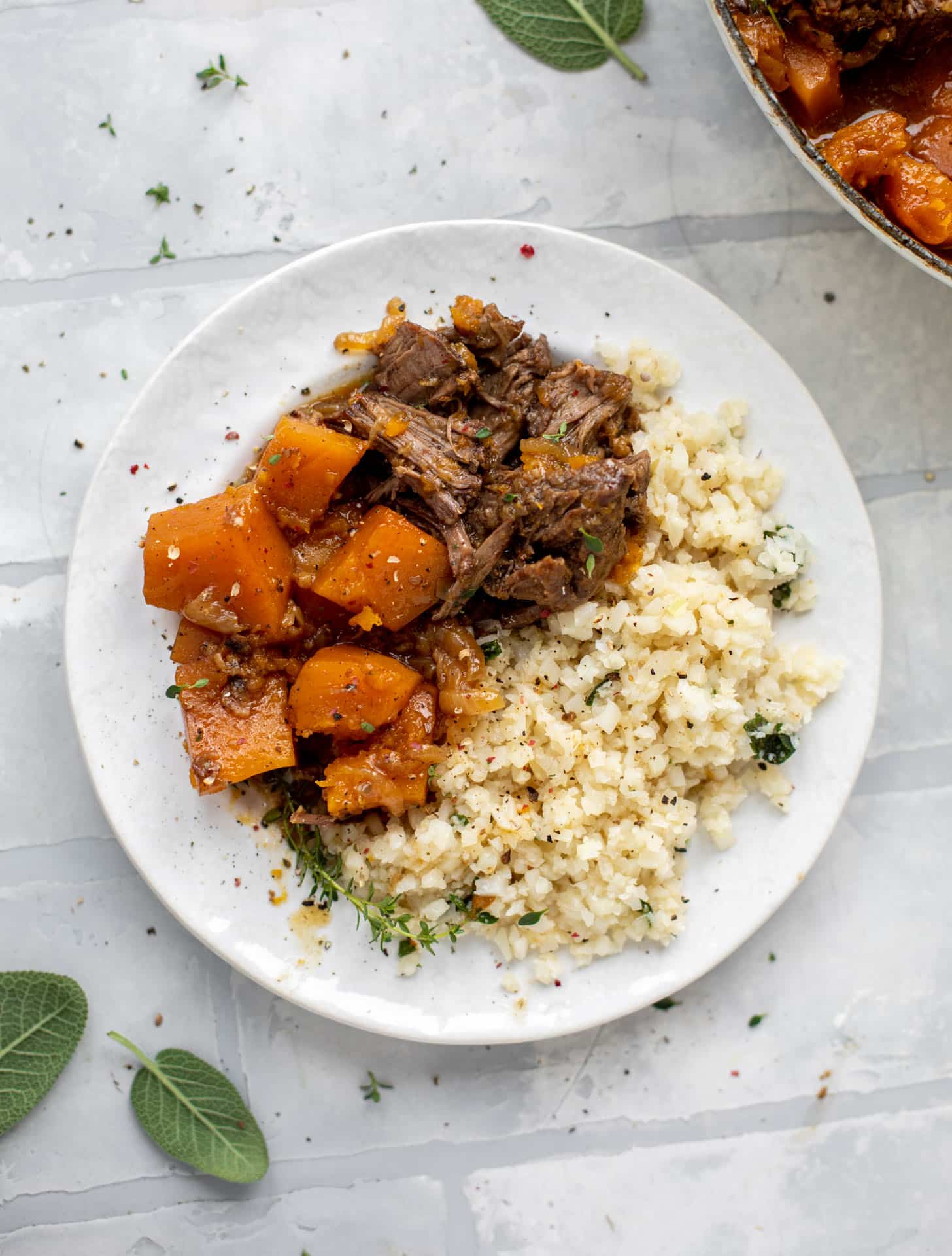 cider braised pot roast with caramelized onions, butternut squash and cauliflower rice