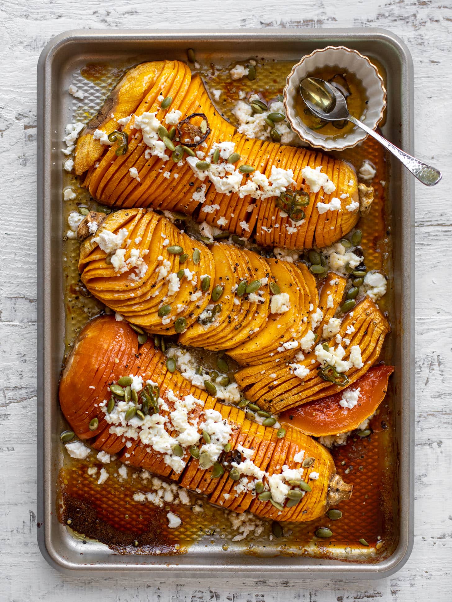 hot honey hasselback butternut squash with feta and pepitas