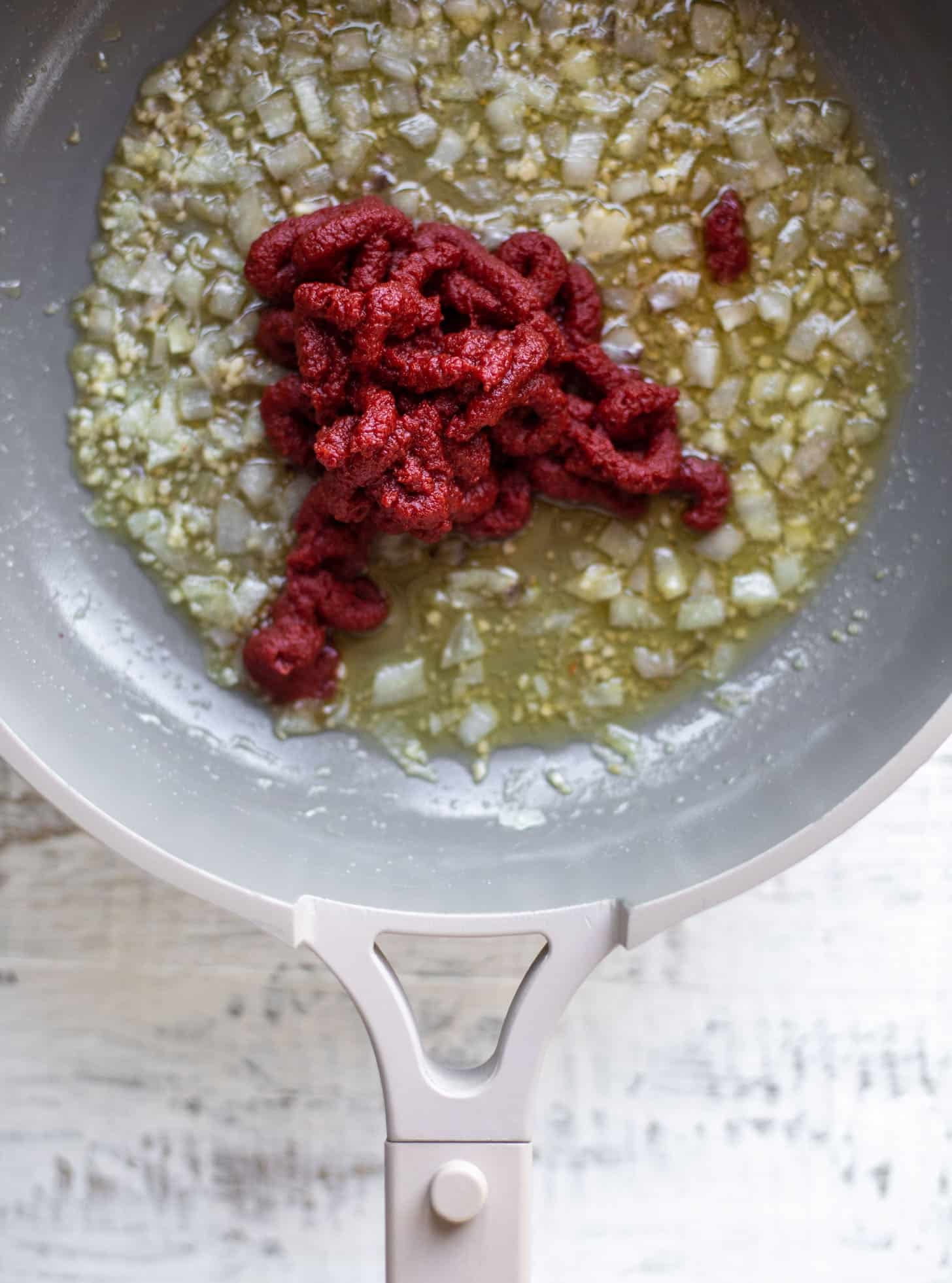 tomato paste with sautéed onions and garlic