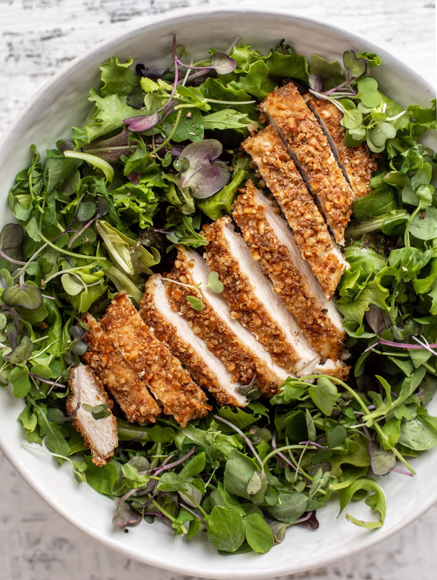 pretzel crusted chicken on spring greens