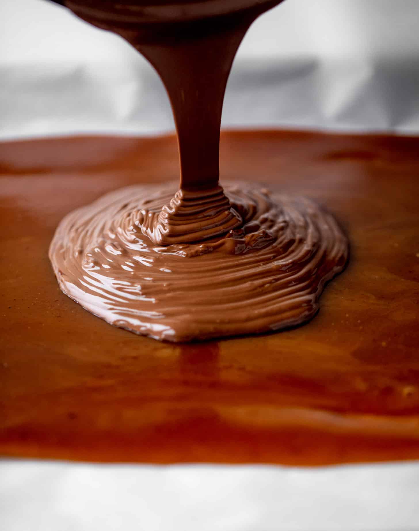 pouring chocolate onto toffee