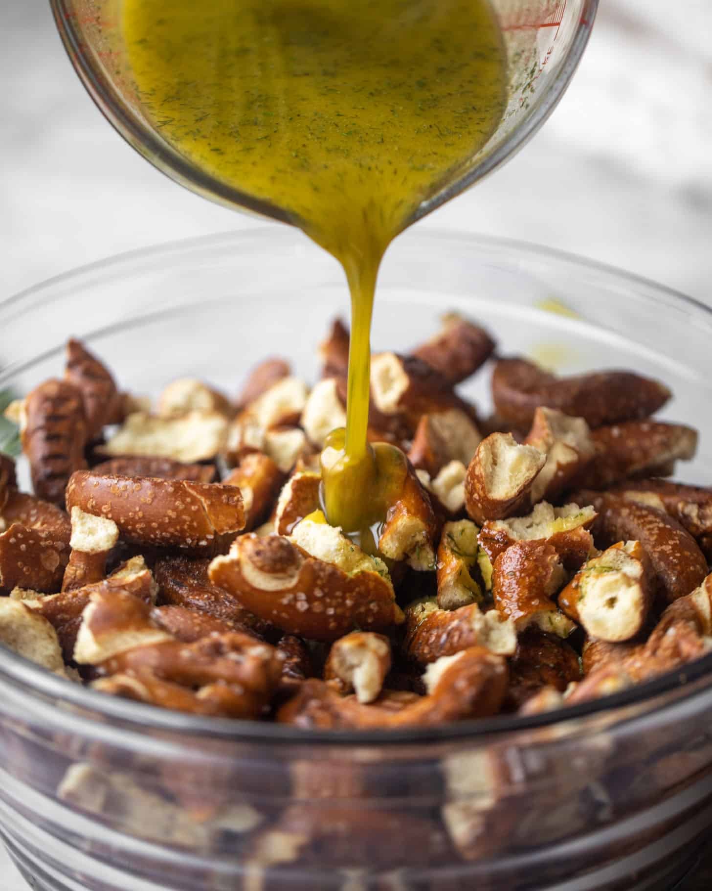 pouring seasoning on the pretzels