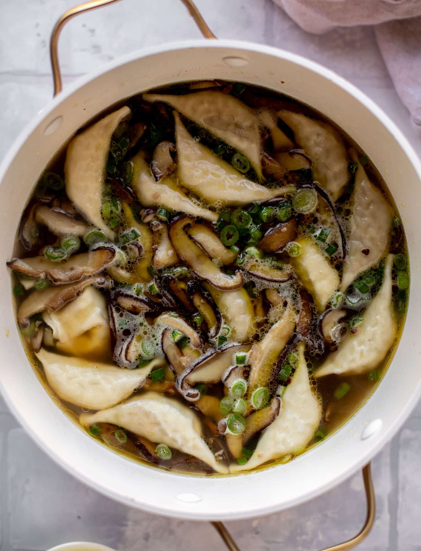 broth with mushrooms and potstickers