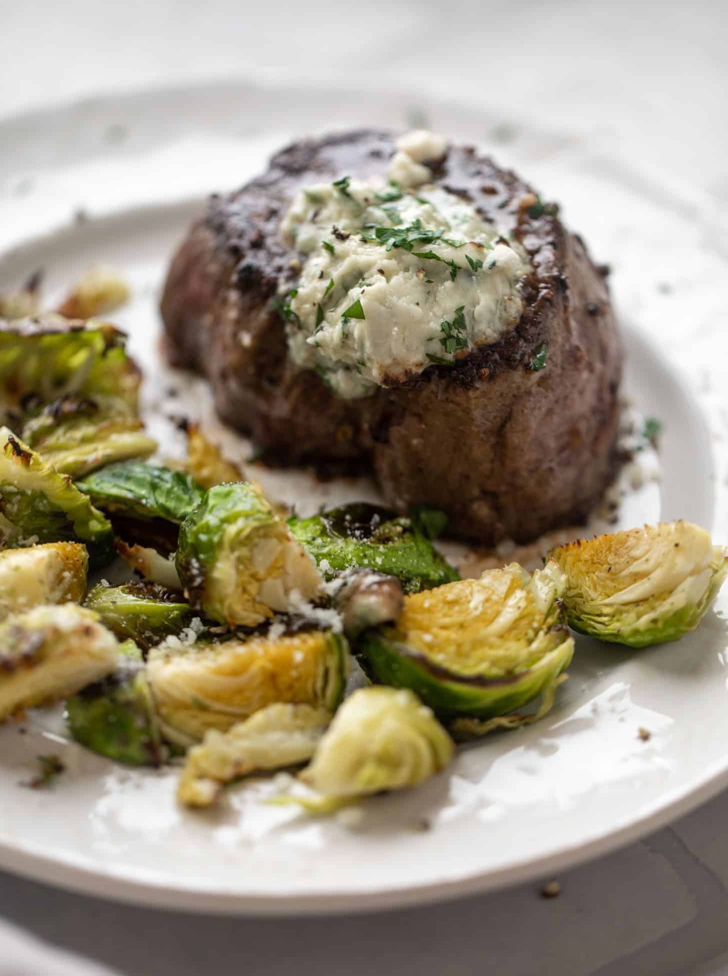 filet mignon with blue cheese butter and cacio e pepe brussels