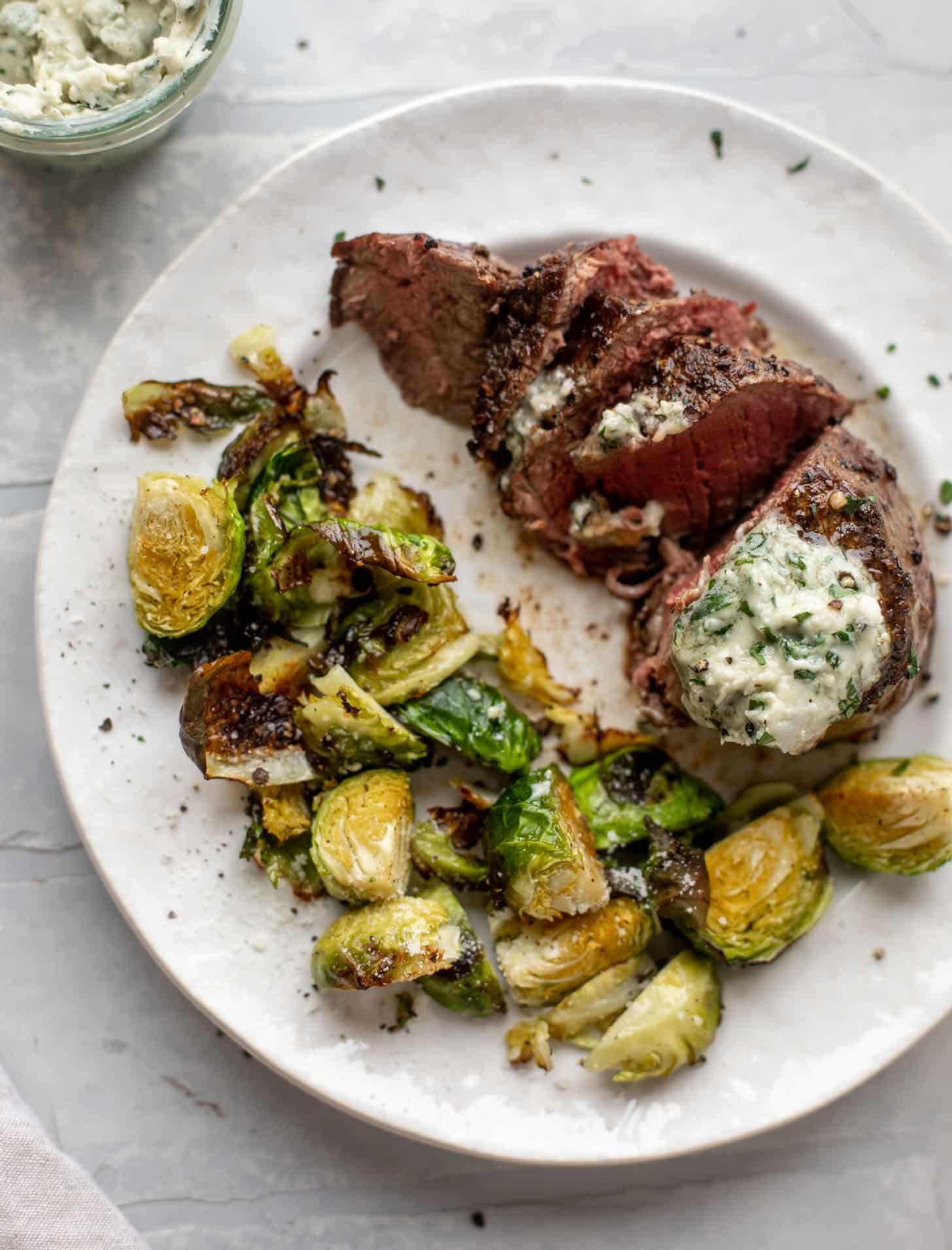 filet mignon with blue cheese butter and cacio e pepe brussels