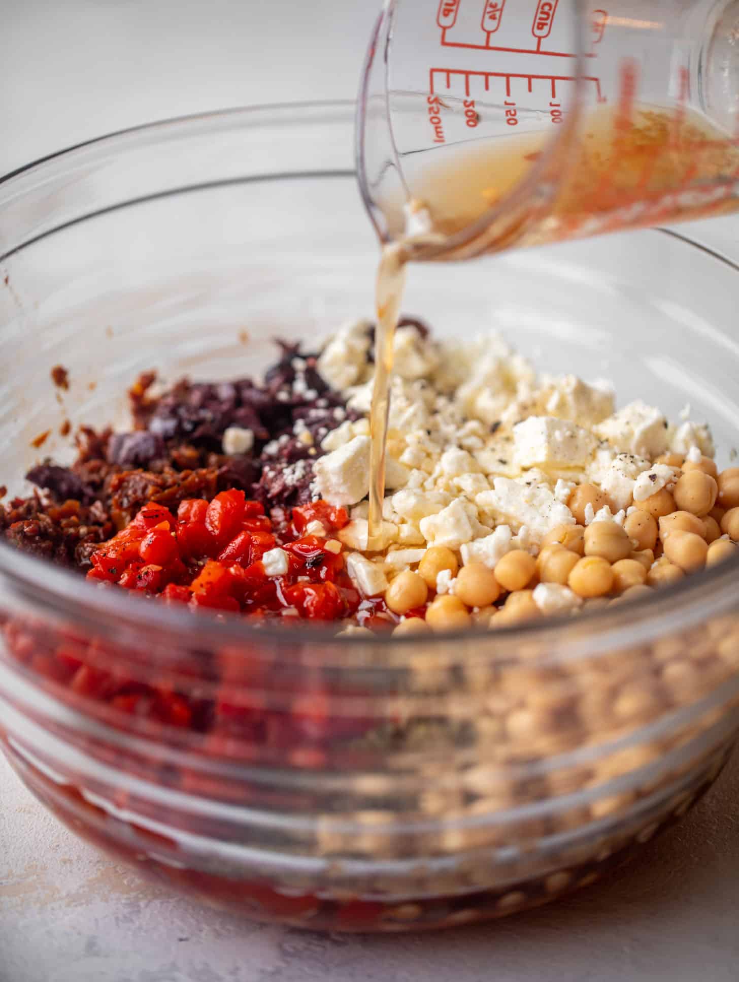 pouring vinaigrette on ingredients