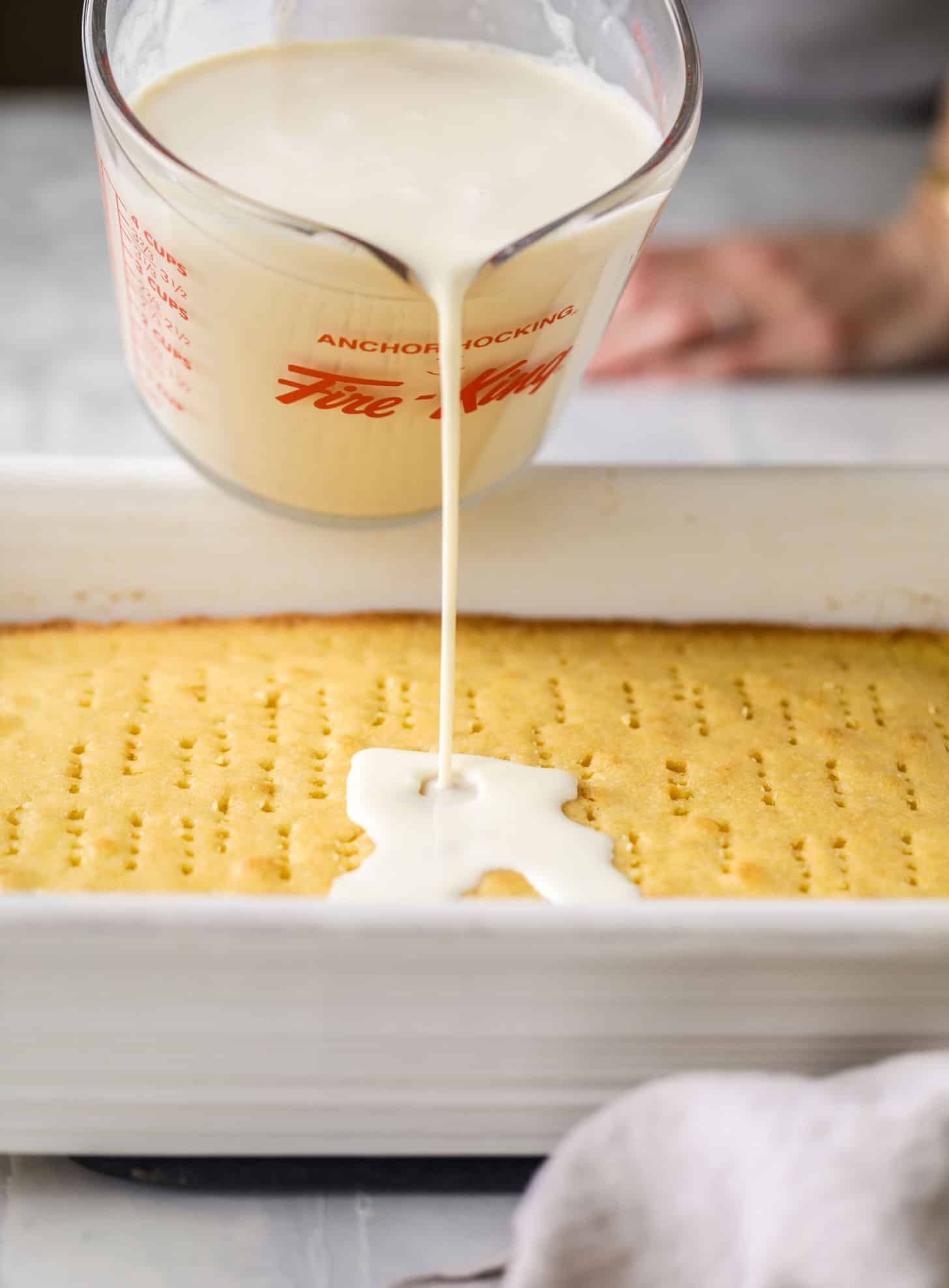 pour milk on tres leches cake