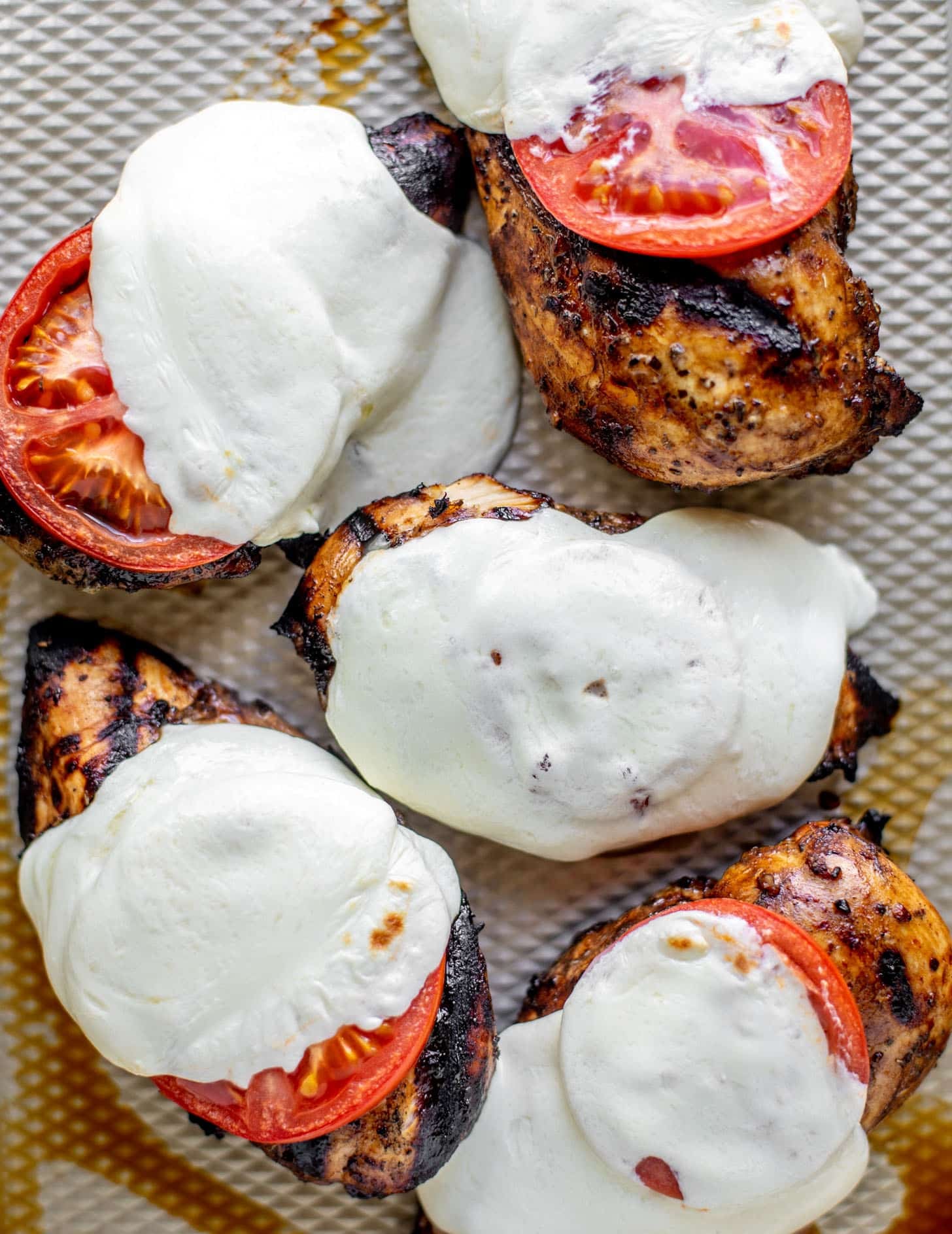 chicken with tomatoes and cheese off the grill