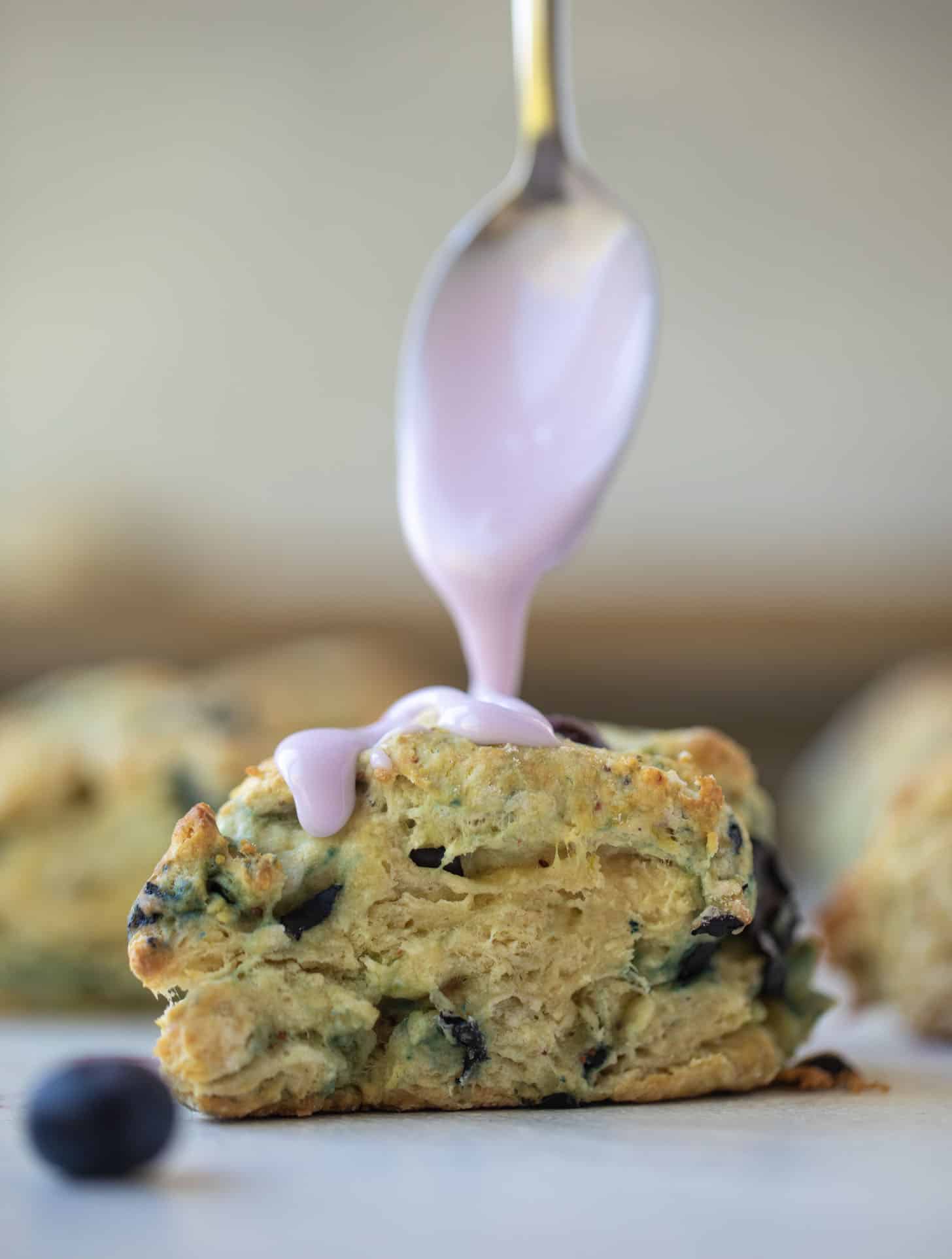 drizzling lavender glaze on blueberry scone