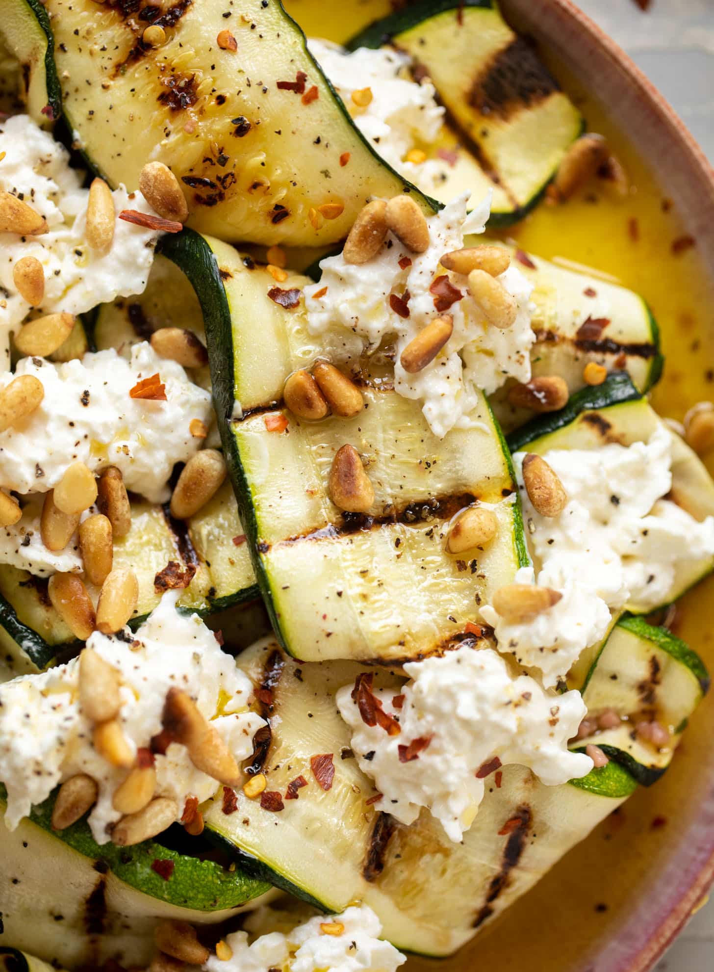 grilled zucchini with burrata and pine nuts