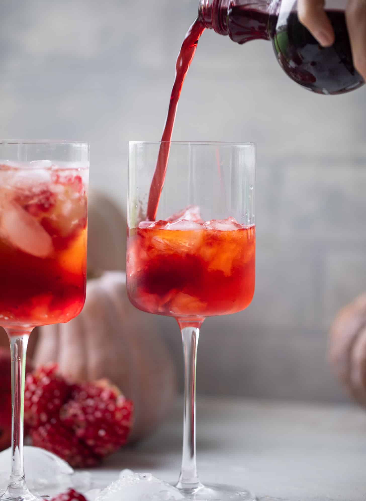 pouring pomegranate juice into a glass