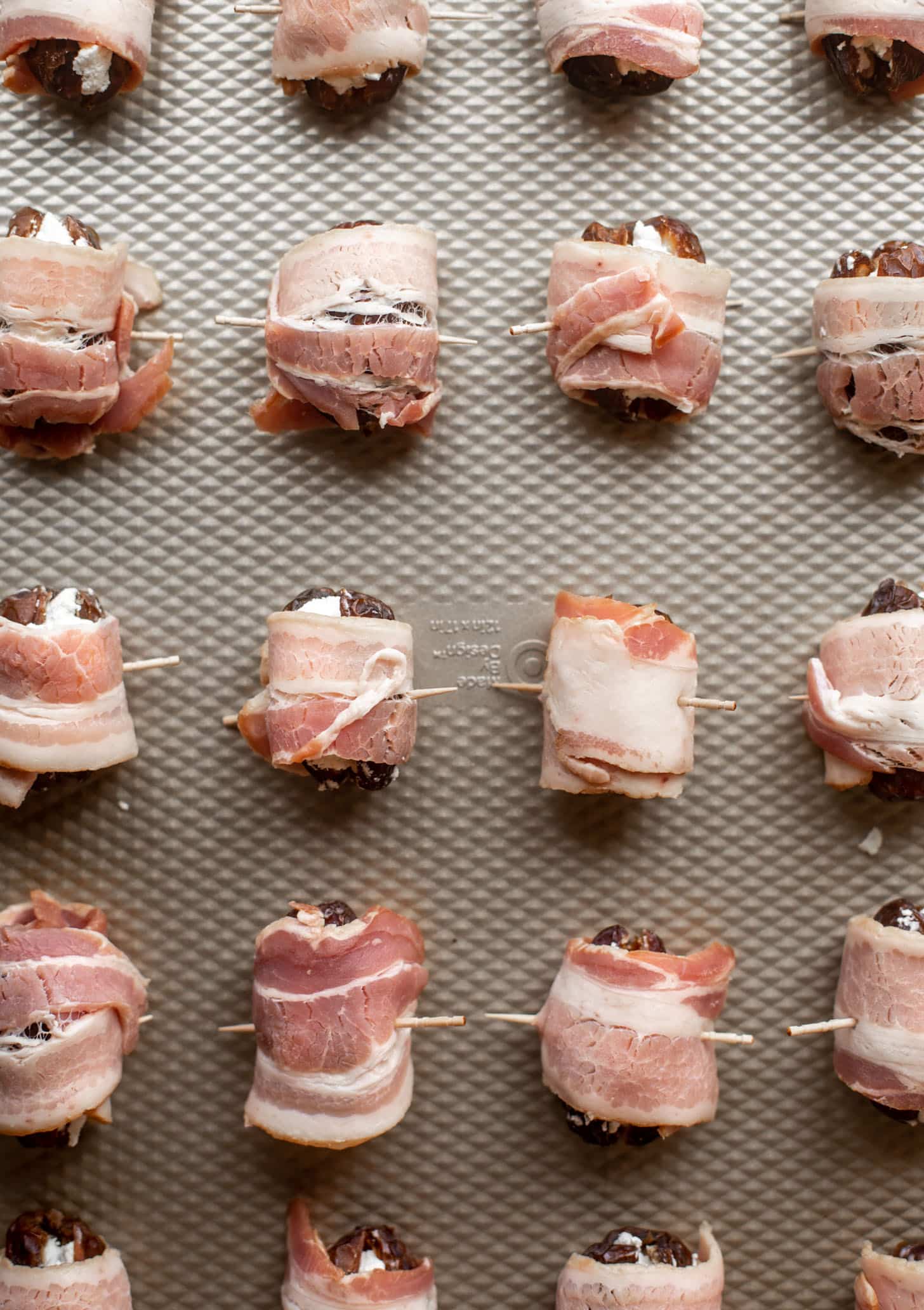 bacon wrapped goat cheese stuffed dates ready for the oven