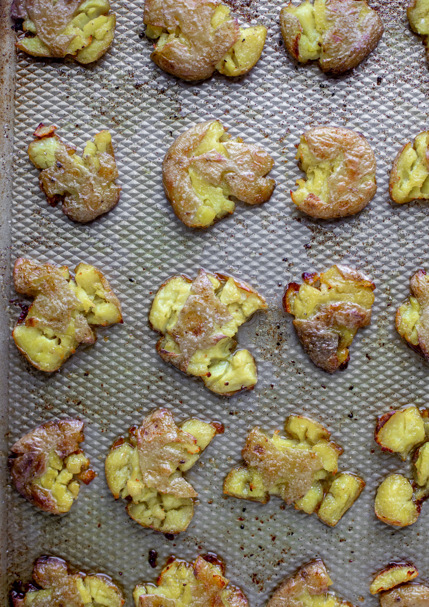 smashed potatoes on baking sheet