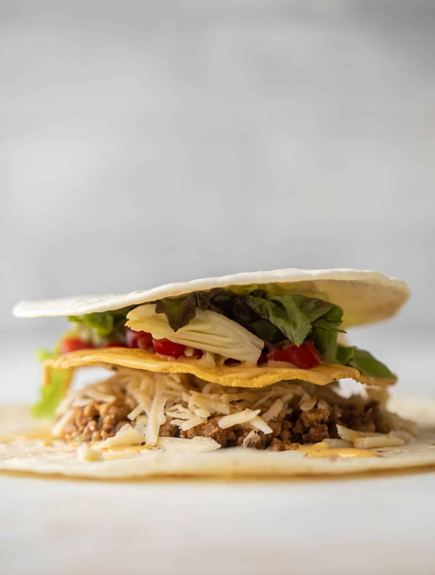 layering a cheeseburger crunchwrap